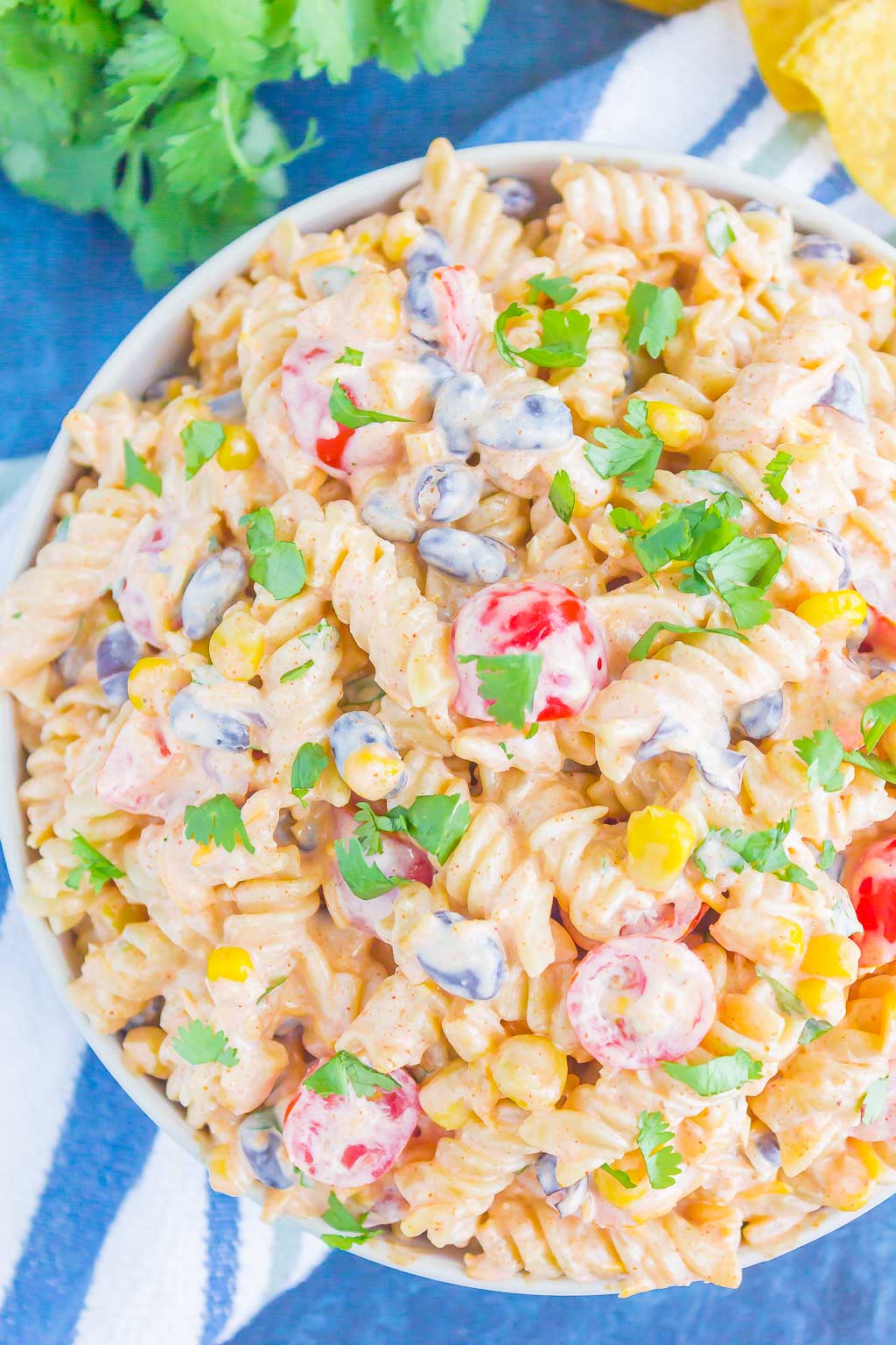 Overhead view of creamy pasta salad in a large serving bowl. 