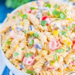 Taco Pasta Salad is loaded with Mexican flavors and ready in no time. With a creamy, zesty dressing and all of your favorite toppings, this easy pasta salad is perfect for your next party!