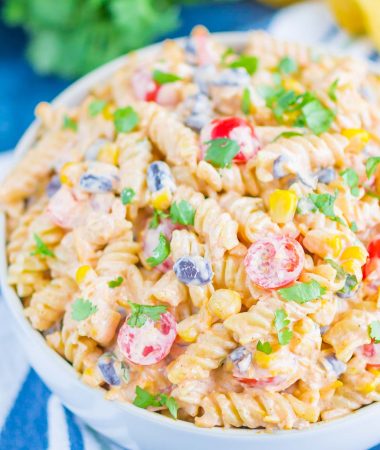 Taco Pasta Salad is loaded with Mexican flavors and ready in no time. With a creamy, zesty dressing and all of your favorite toppings, this easy pasta salad is perfect for your next party!
