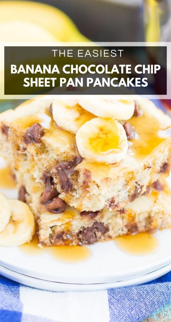 A close-up of two square banana chocolate chip sheet pan pancakes stacked on a plate, topped with banana slices and syrup, with a blue checkered cloth underneath.