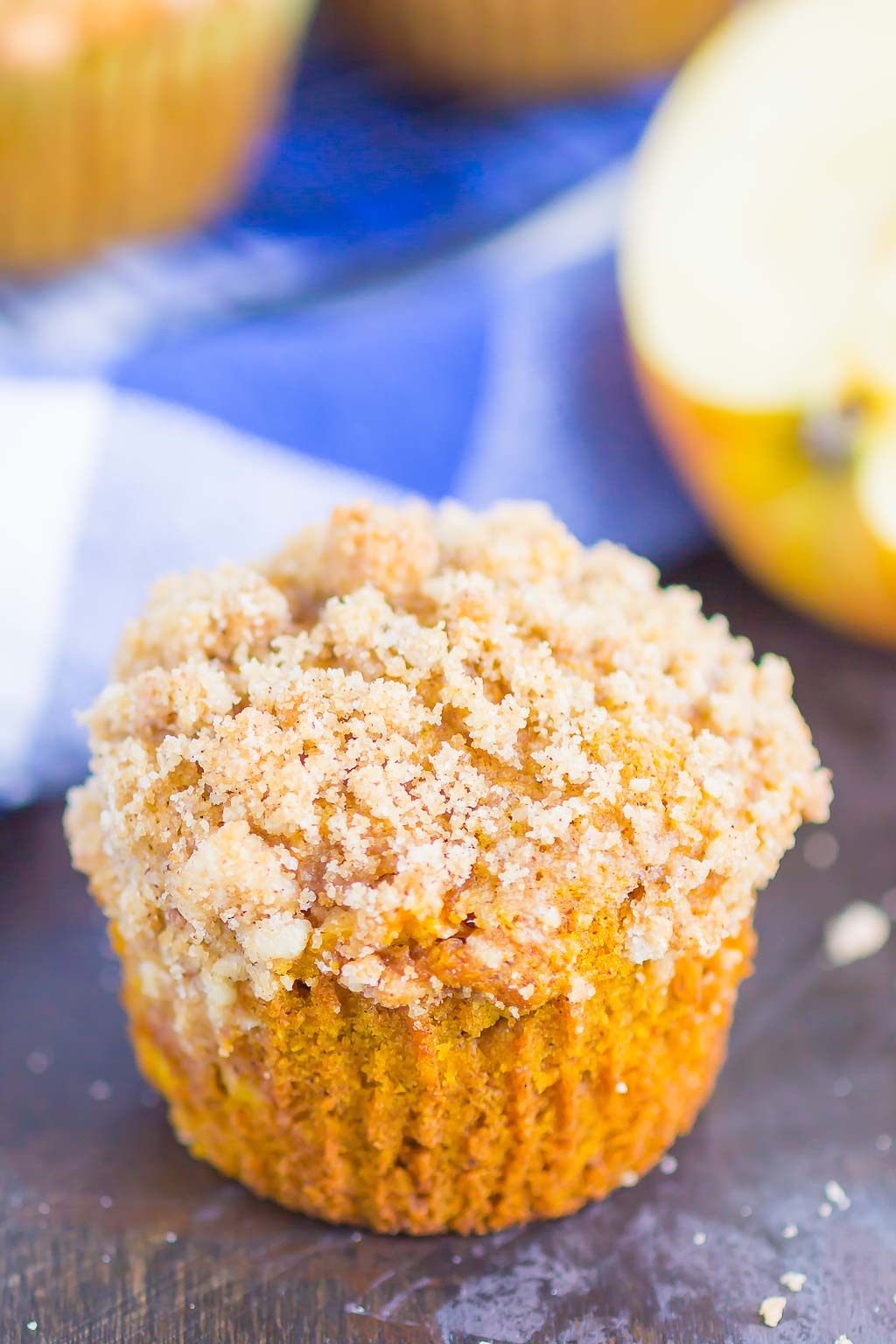 A pumpkin apple muffin topped with streusel topping. 