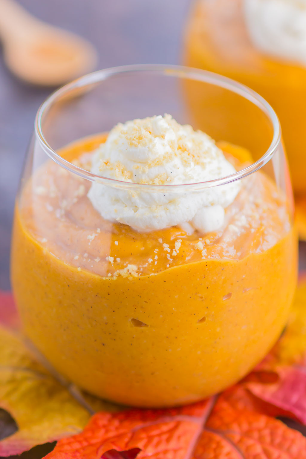 Pumpkin Spice Pudding in a glass, topped with whipped cream. 