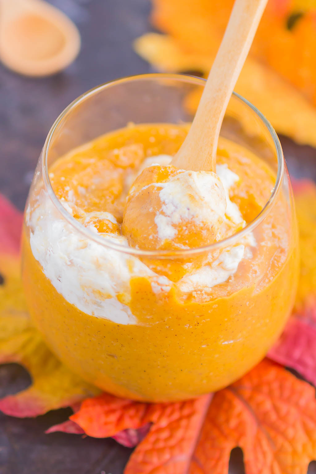 pumpkin pudding in a glass, with a wooden spoon sticking out. 