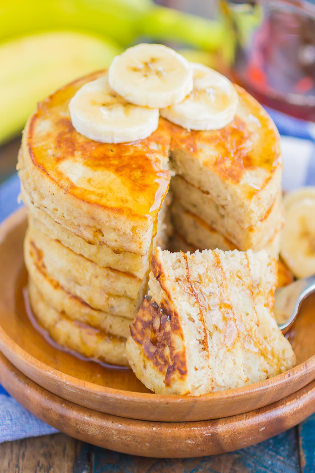 A stack of simple banana pancakes with a forkful speared onto a fork. 