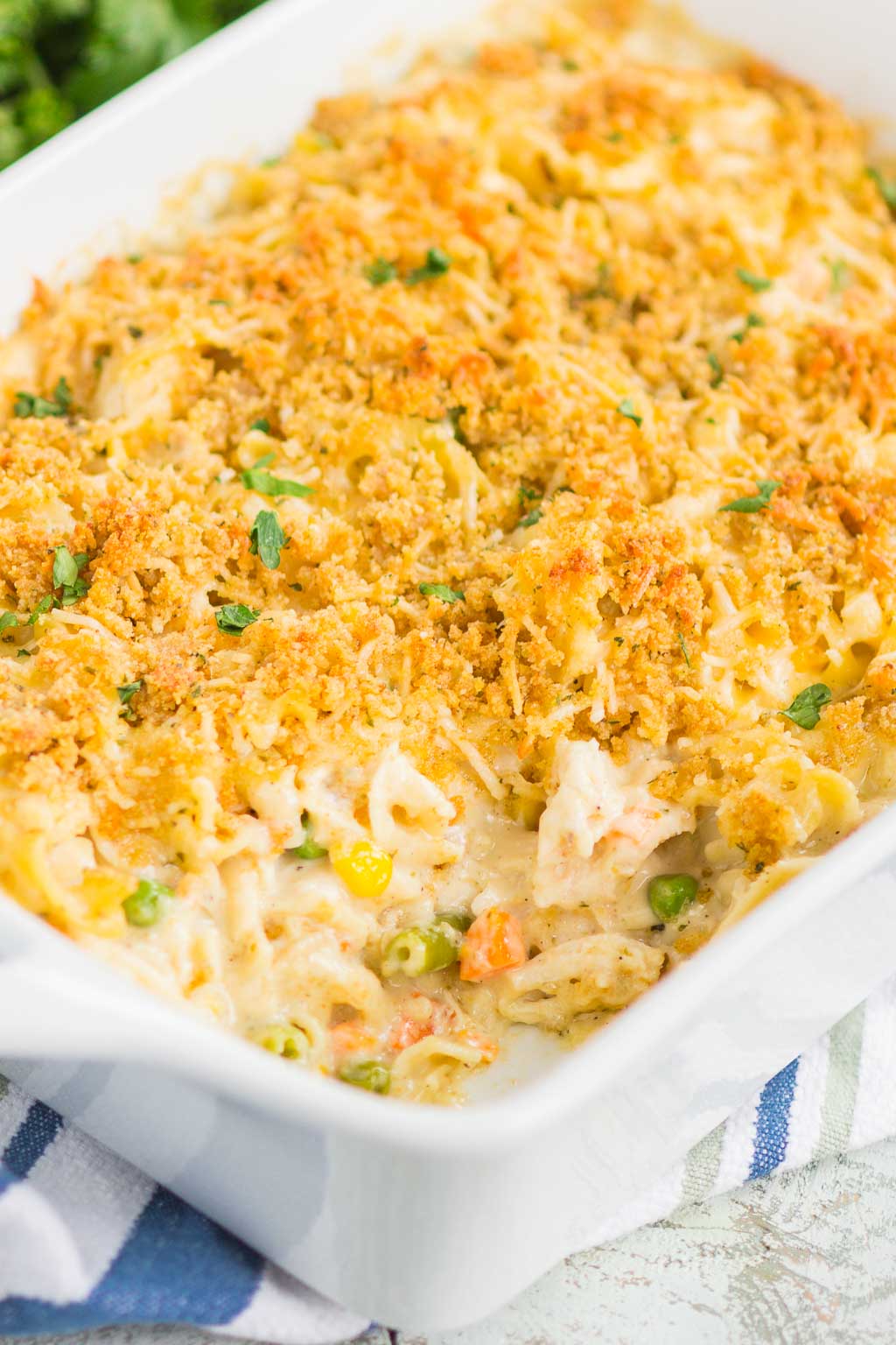 A chicken noodle soup casserole with a serving missing. 