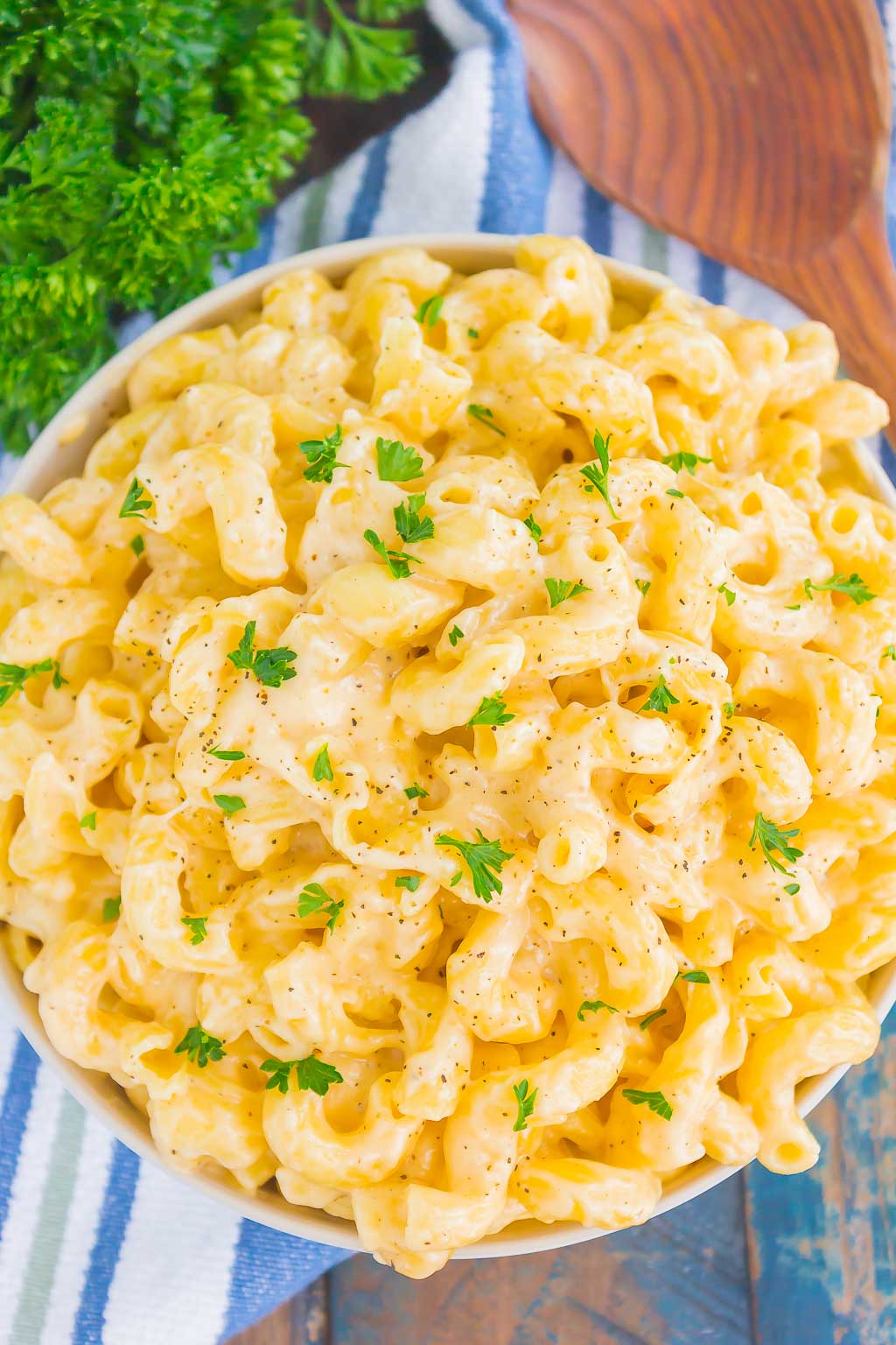 Overhead view of creamy stovetop mac and cheese in a white serving bowl. 