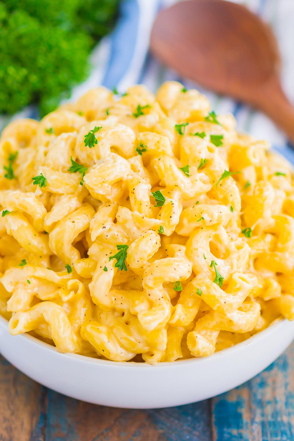 Side view of homemade creamy mac and cheese in a large white bowl. 