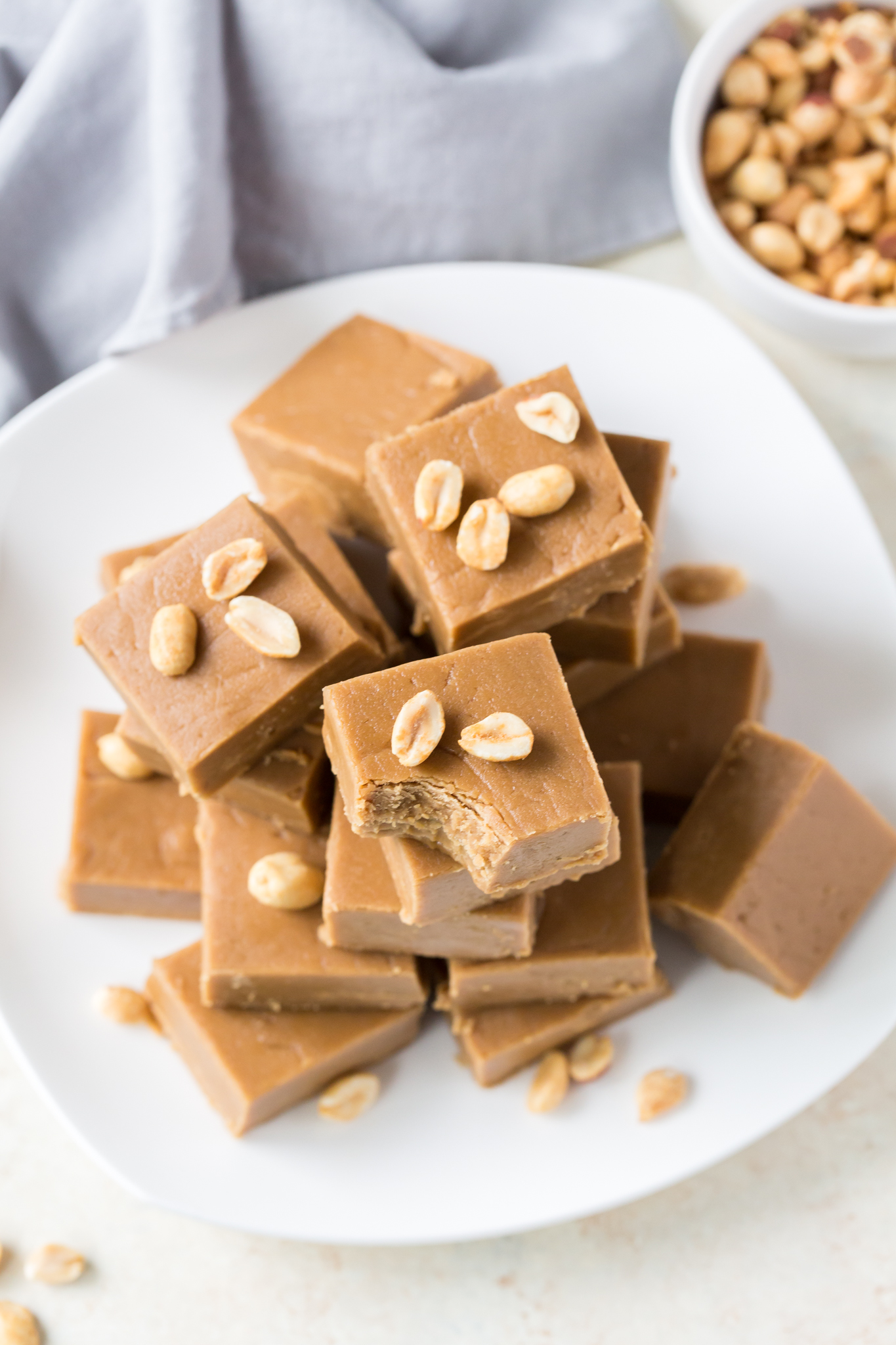 Peanut Butter Fudge piled high on a white plate. 