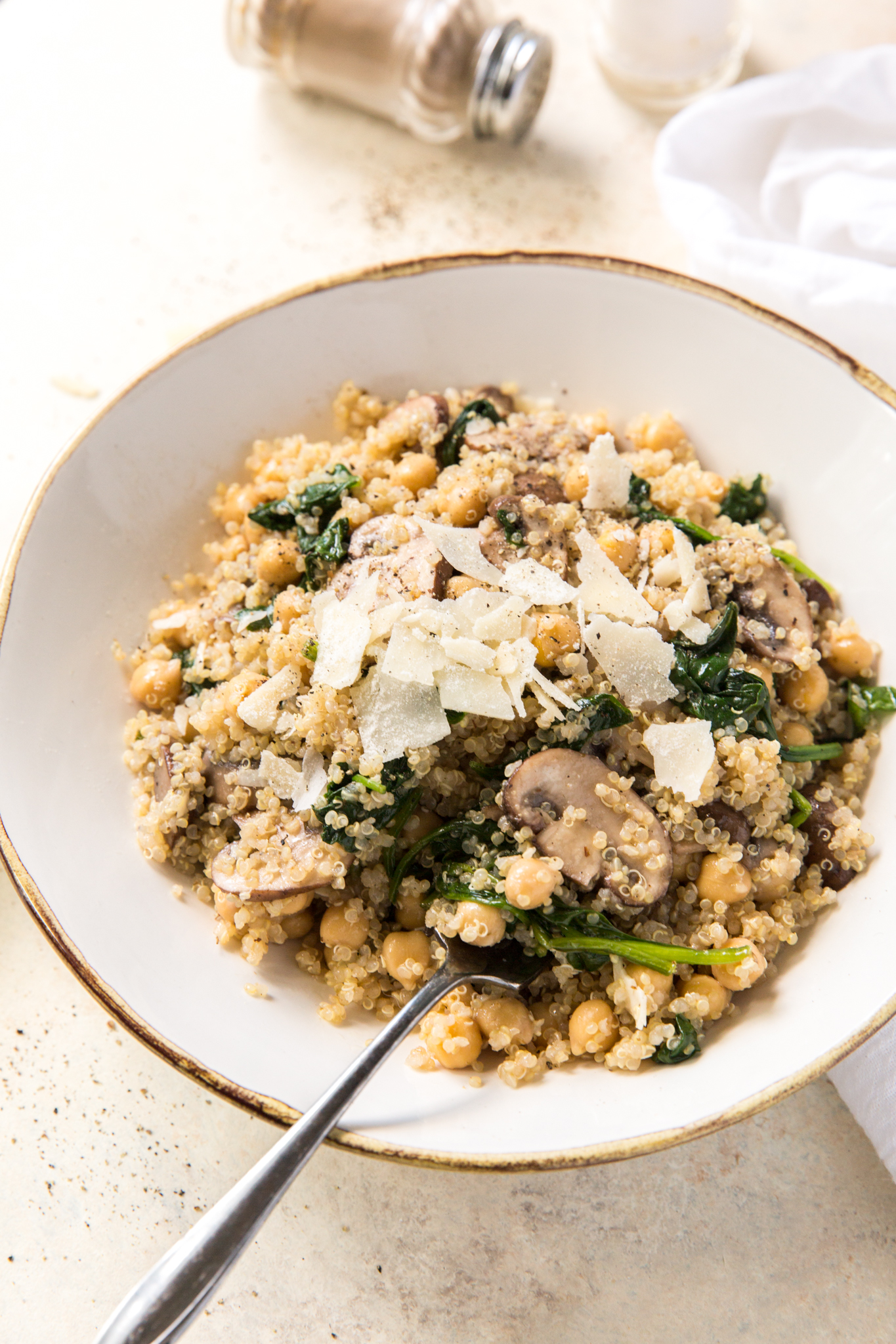 a healthy quinoa bowl topped with parmesan 