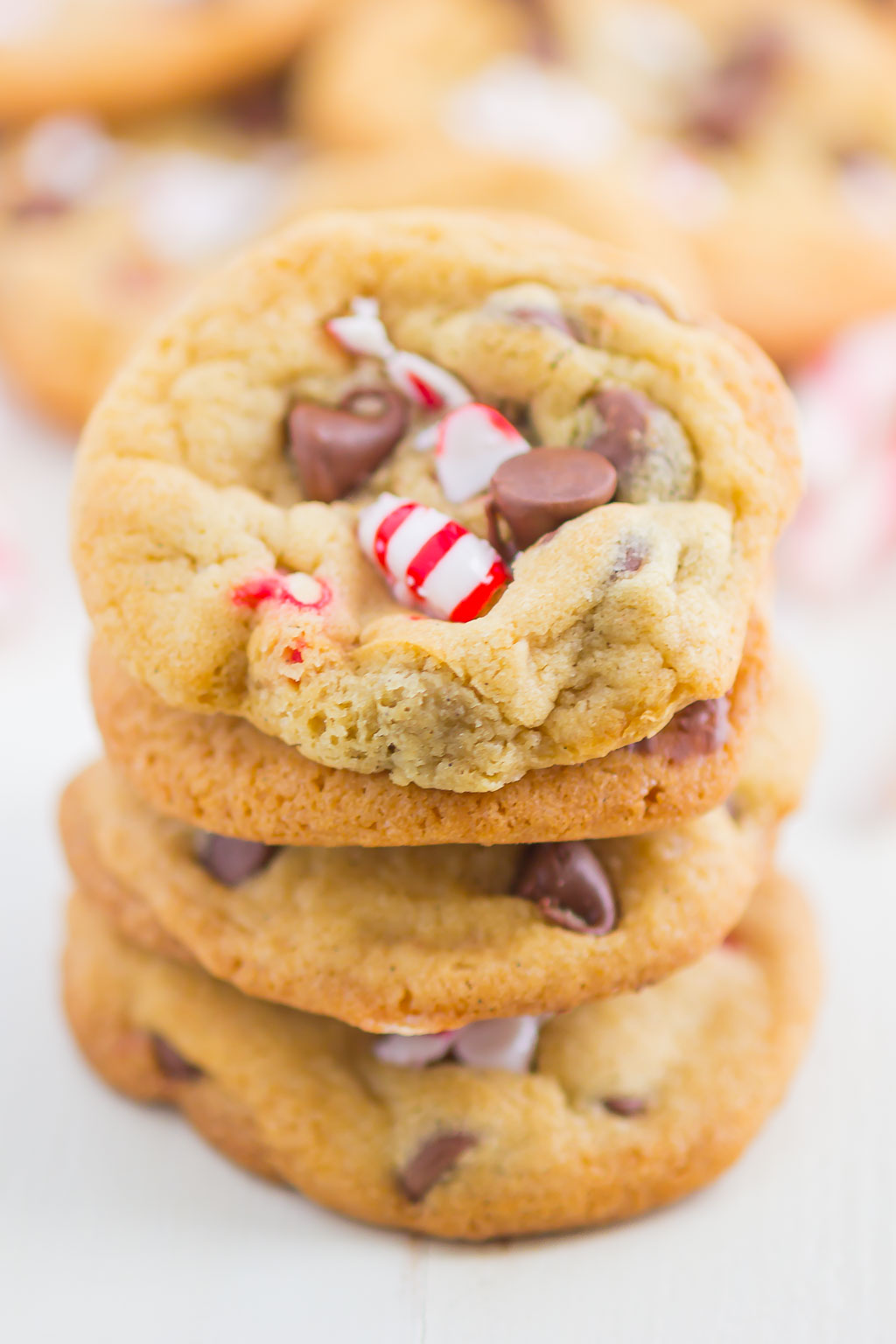 A stack of four chocolate chip and crushed candy cane cookies. 
