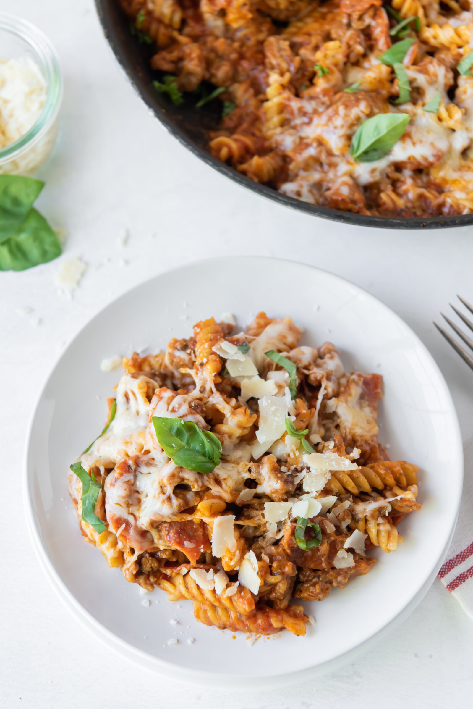 top view of pizza pasta casserole on a white plate