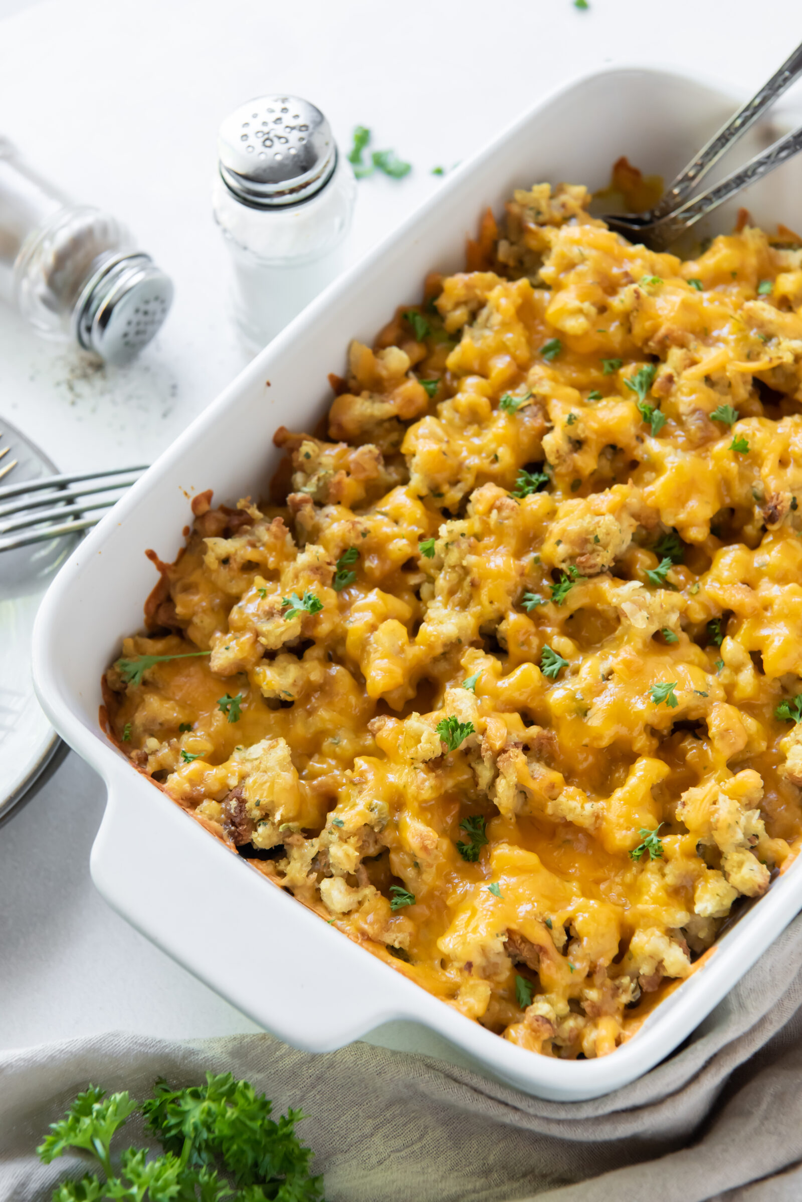 An overhead view of chicken broccoli stuffing casserole in a white baking dish. 