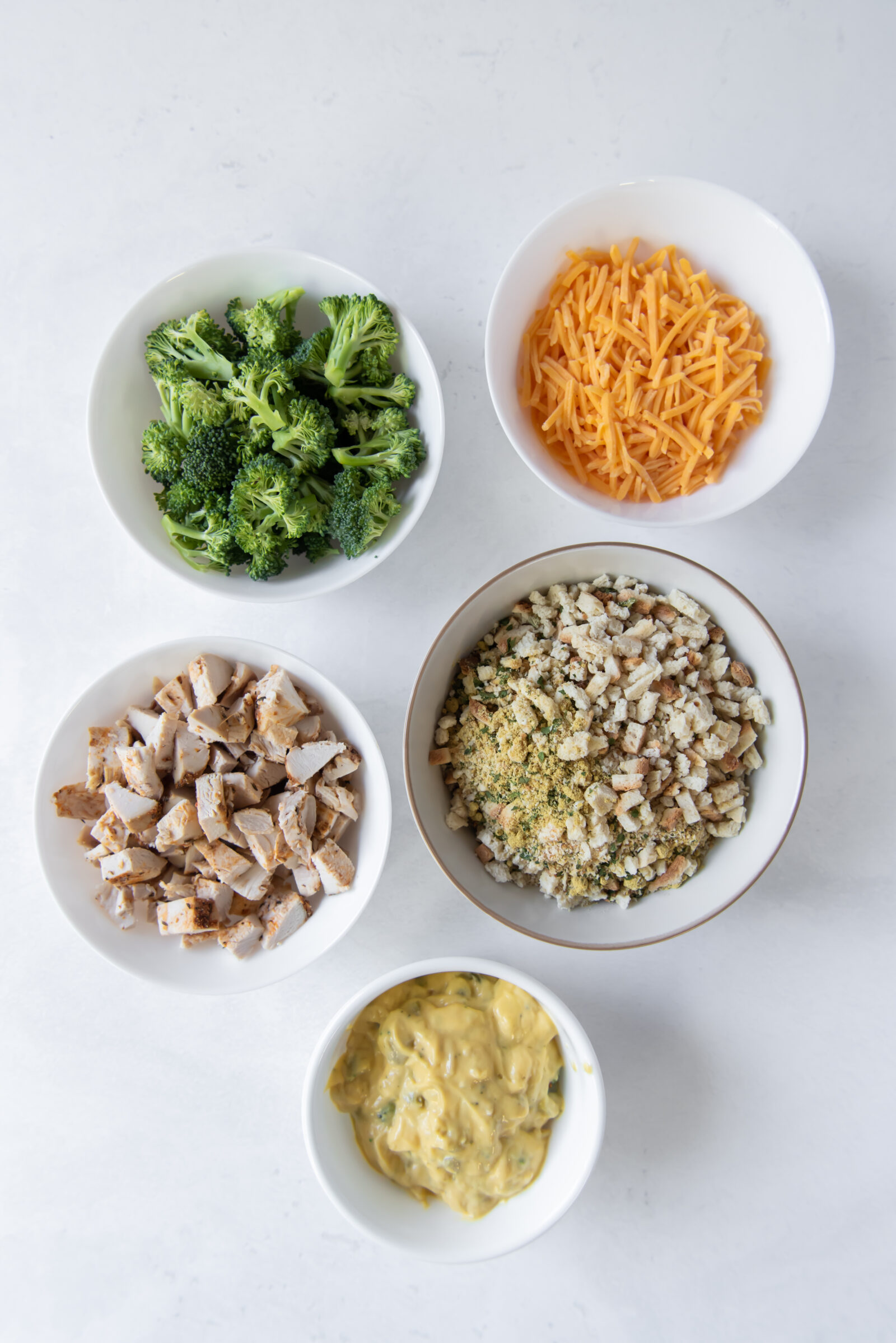 An overhead view of the ingredients needed for cheesy chicken broccoli casserole. 