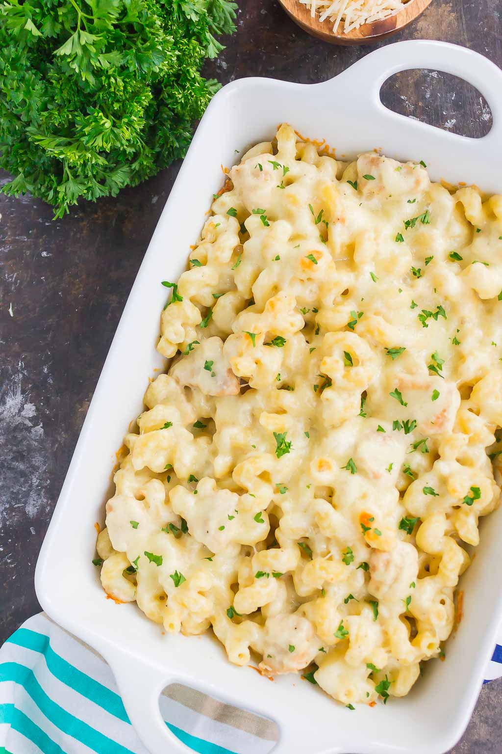 Overhead view of chicken alfredo pasta bake in a white baking dish. 