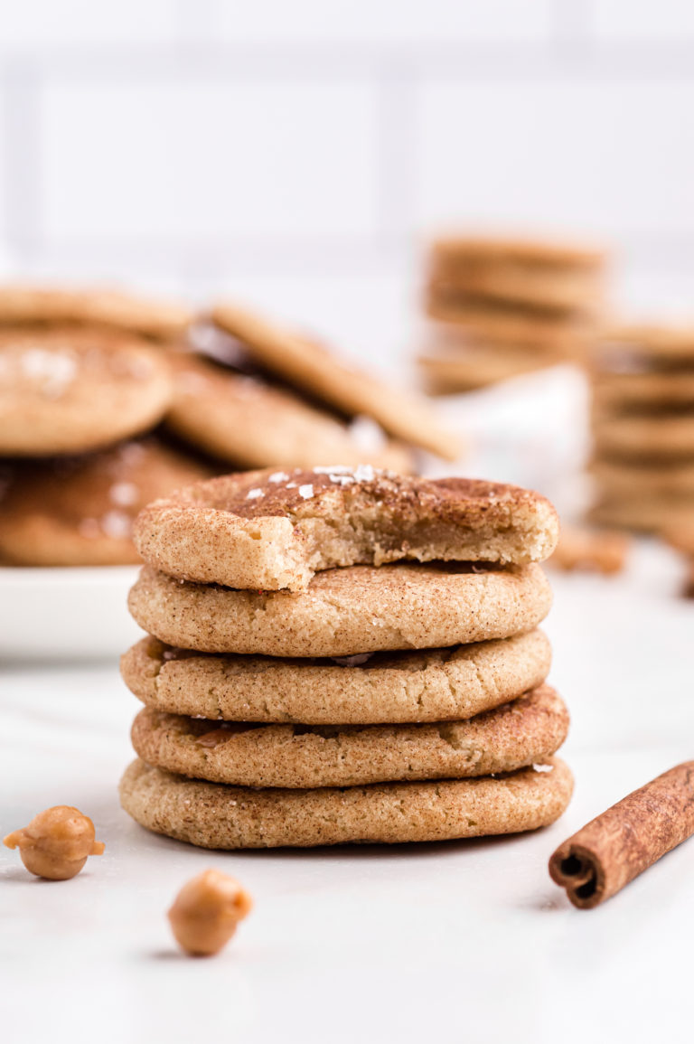 A stack of Salted Caramel Snickerdoodles on a white surface.