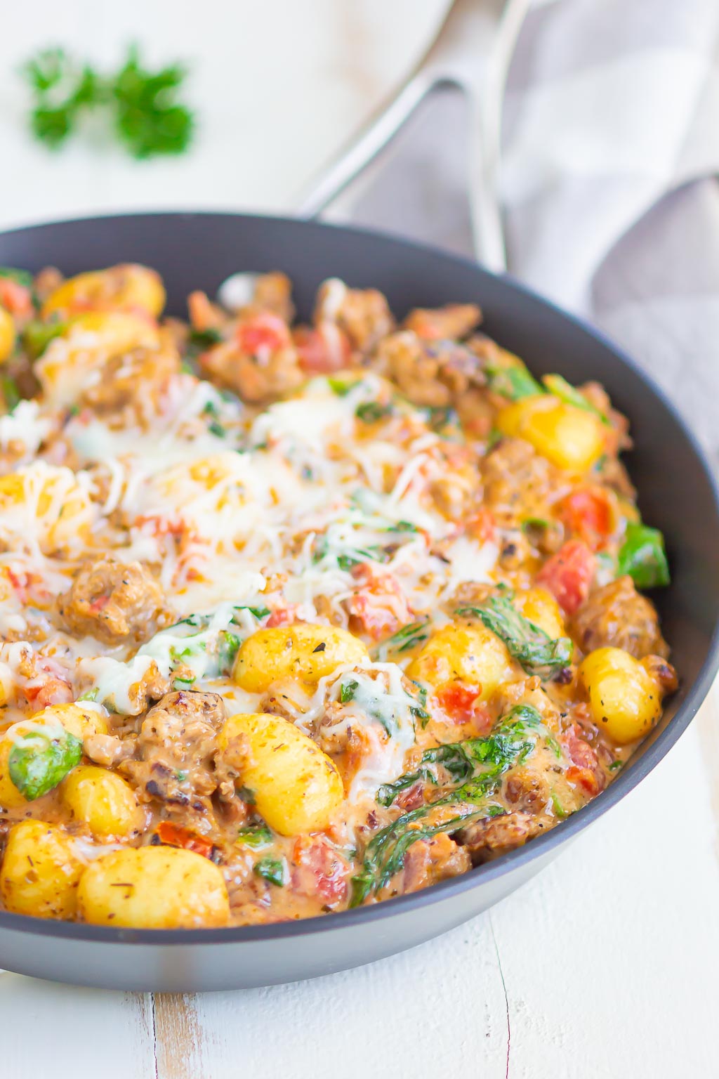 Creamy gnocchi and sausage in a skillet. 