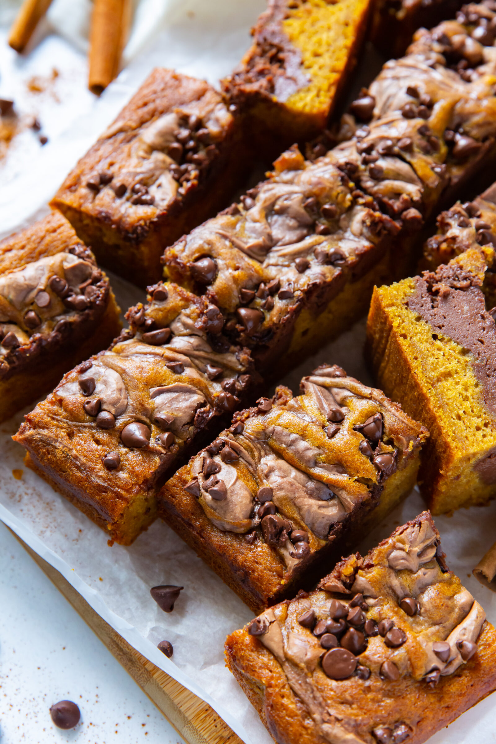 pumpkin cream cheese bars on a brown board