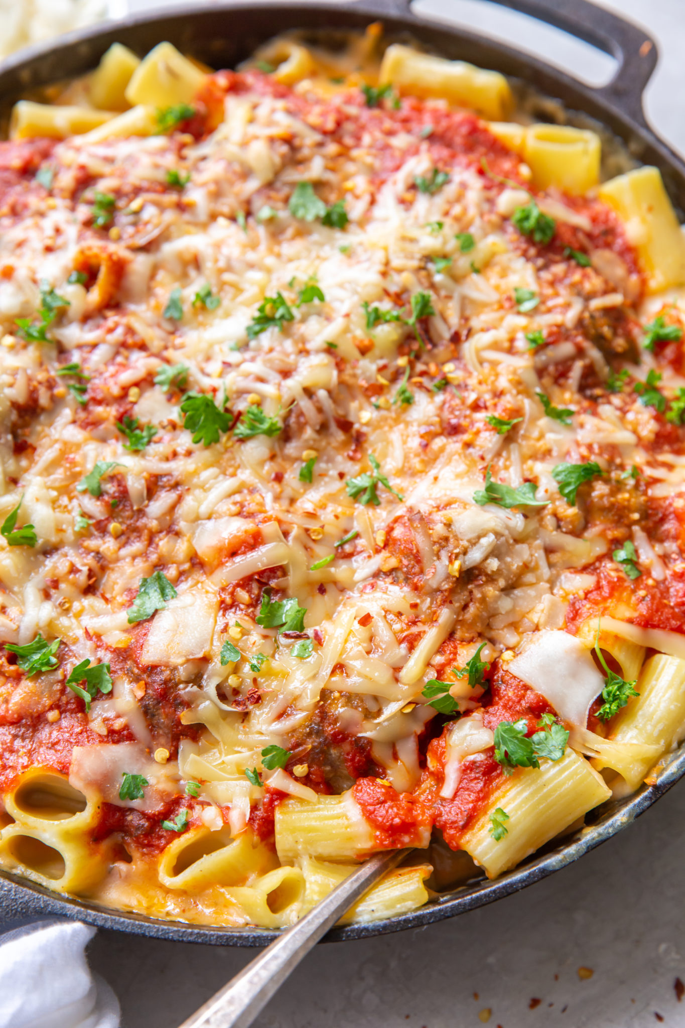 Meatball mac and cheese in a cast iron skillet.