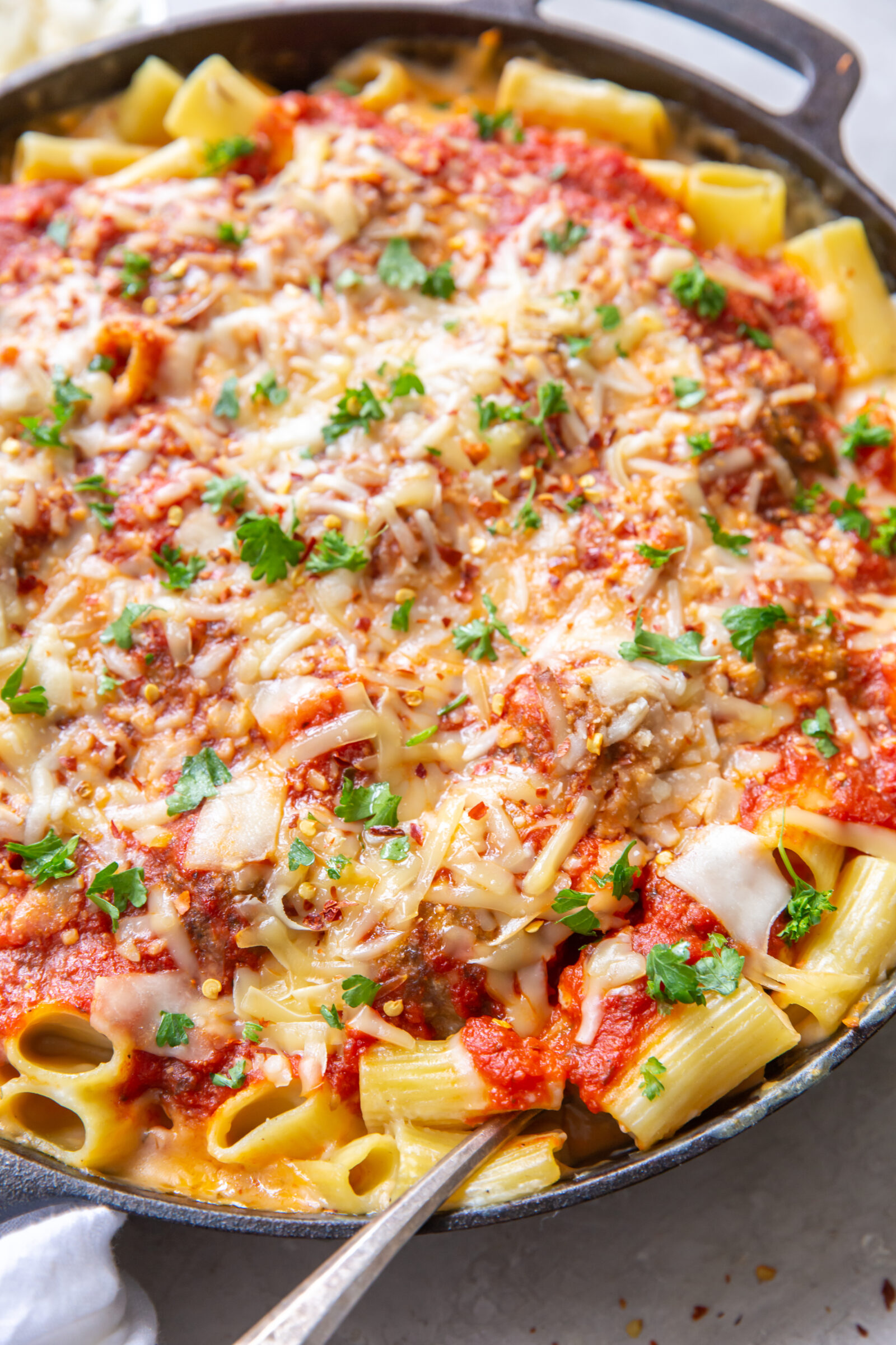 Meatball mac and cheese in a cast iron skillet. 