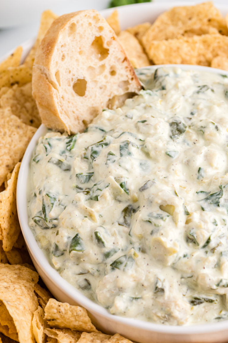 Crock Pot Spinach Artichoke Dip in a white bowl.