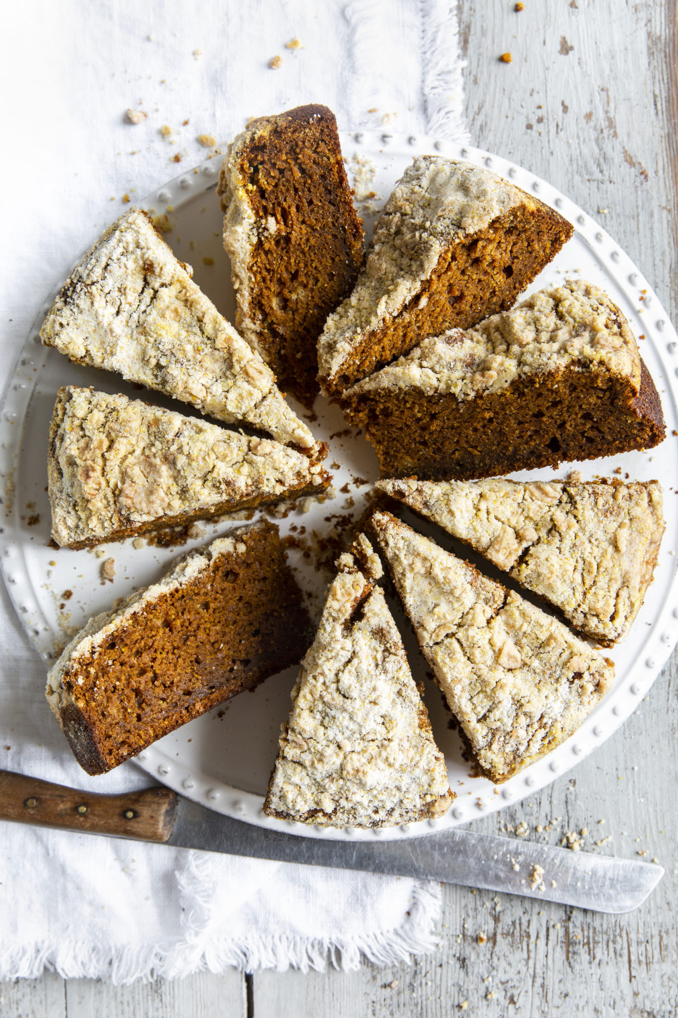 Overhead view of pumpkin streusel coffee cake slices on a white platter.