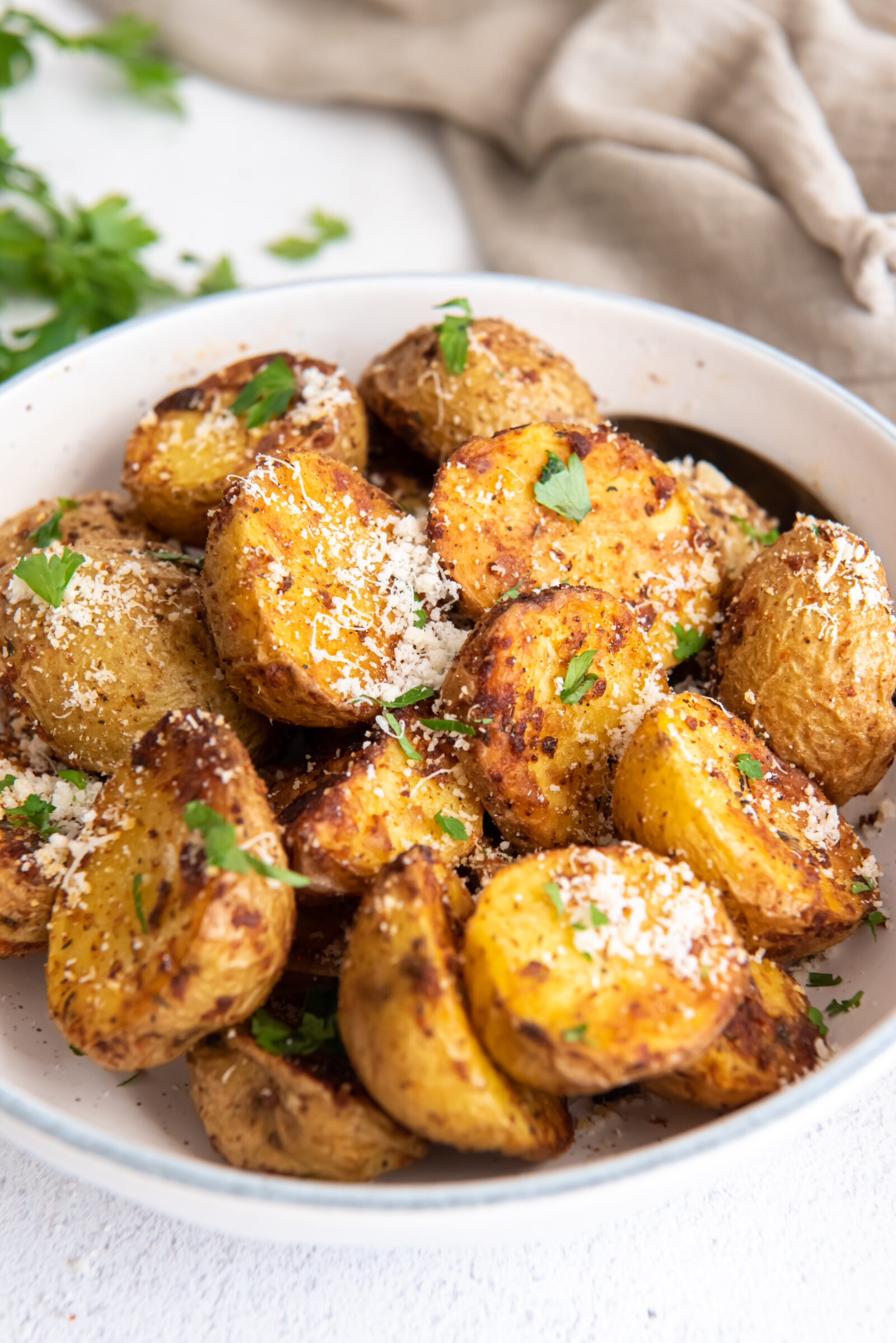 garlic parmesan potatoes in a white dish