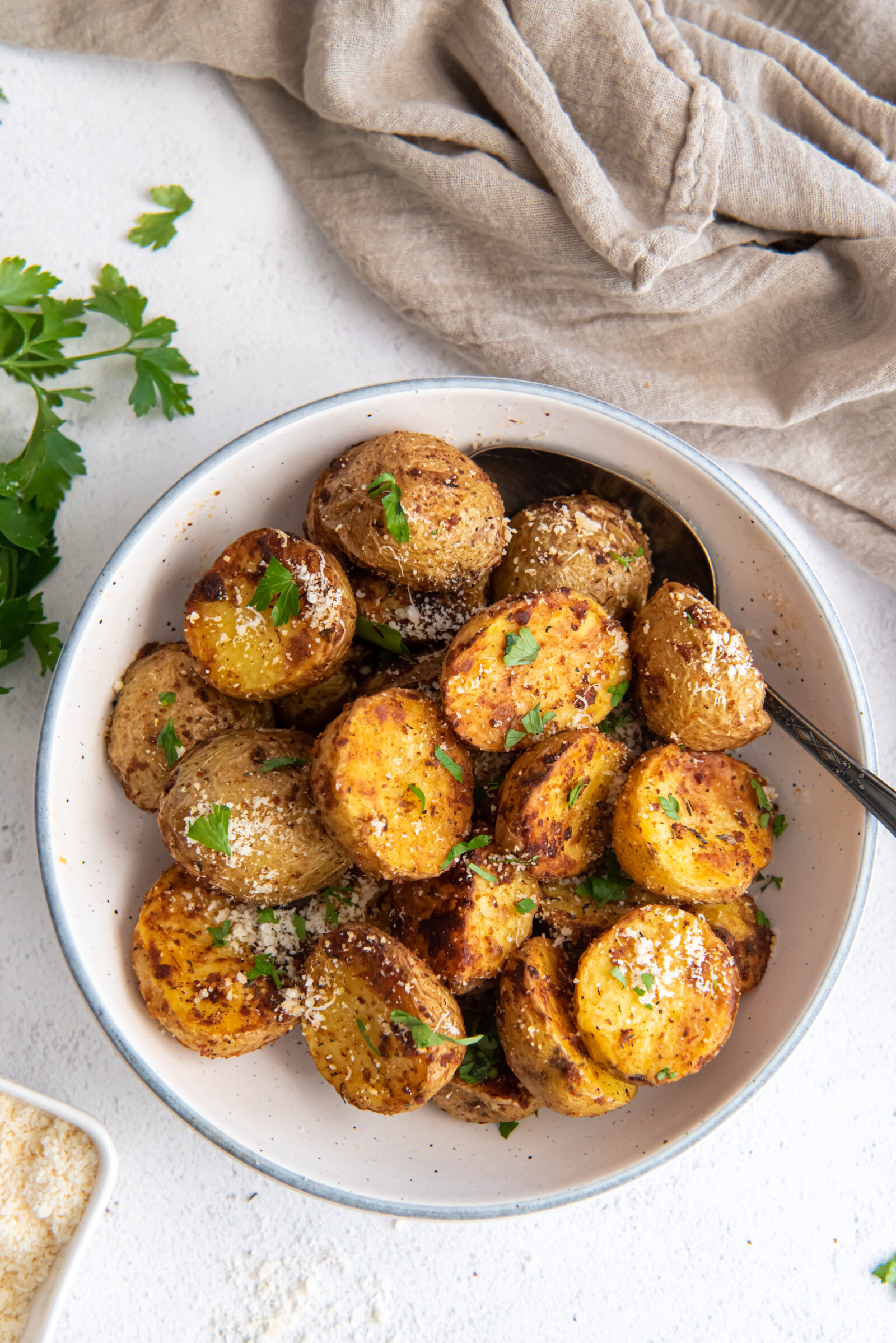 overhead view of garlic parm potatoes in a white dish