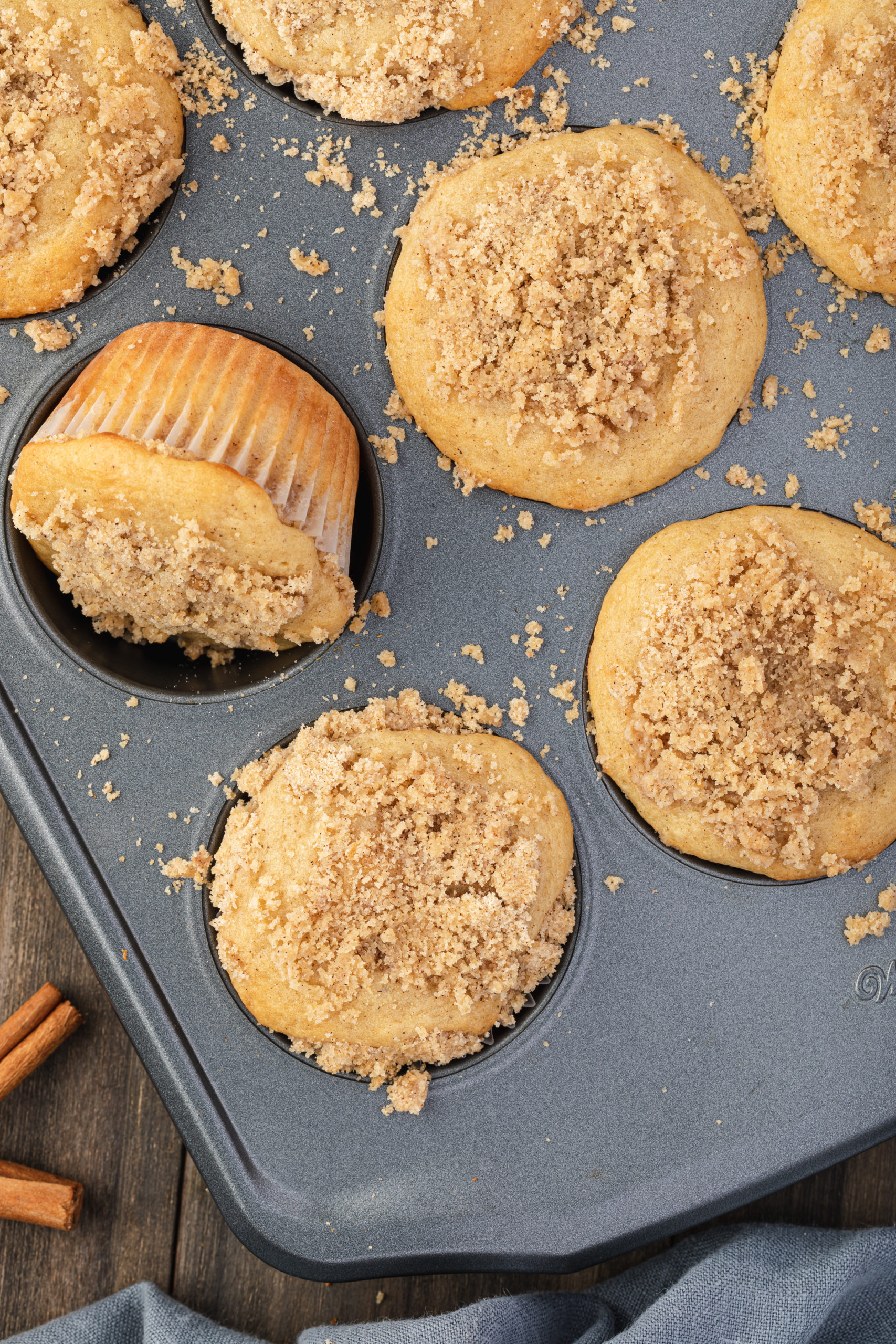 An overhead view of cinnamon streusel muffins made with pancake mix in a muffin tin. 