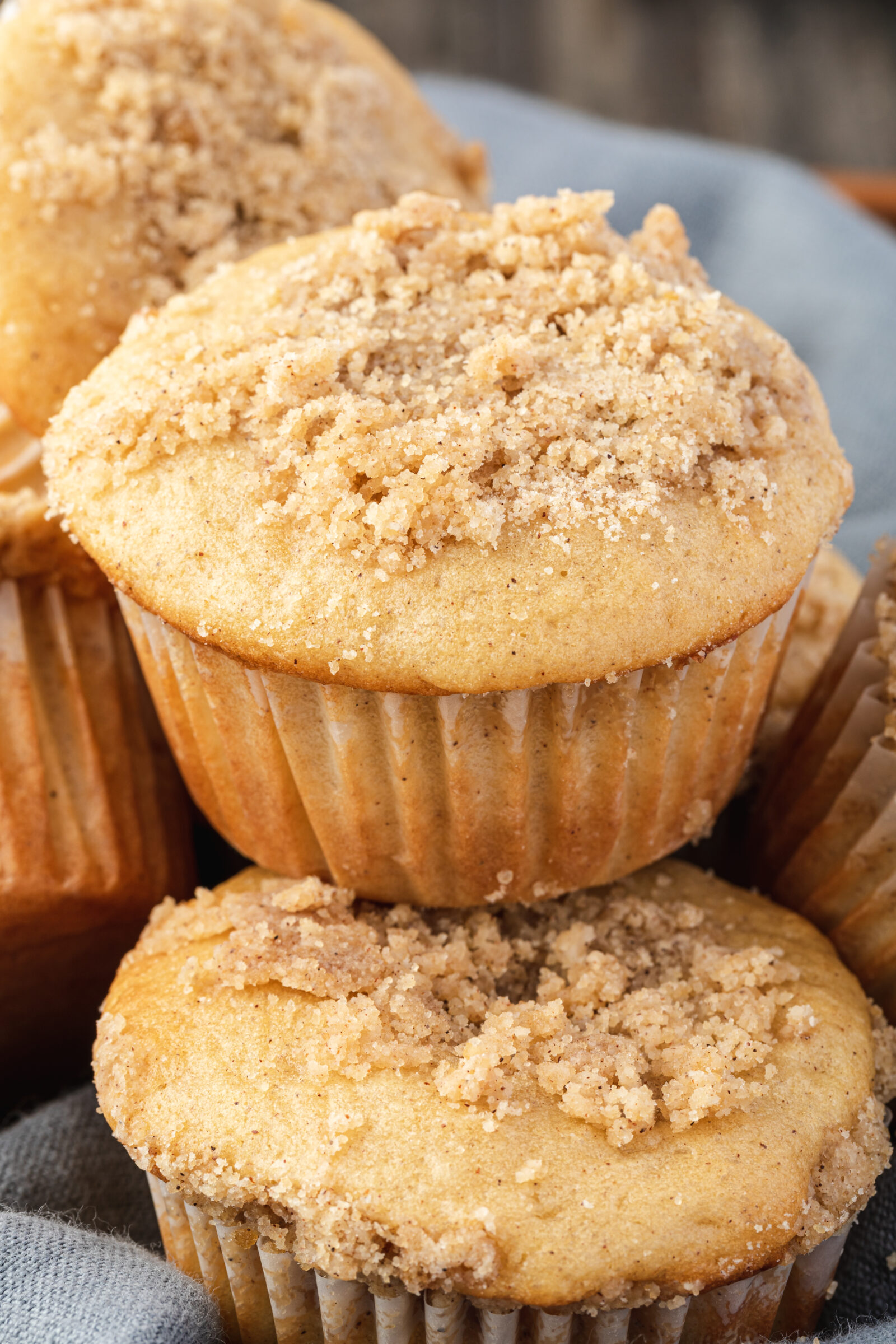 Close up of a cinnamon streusel pancake mix muffins in a towel-lined basket. 