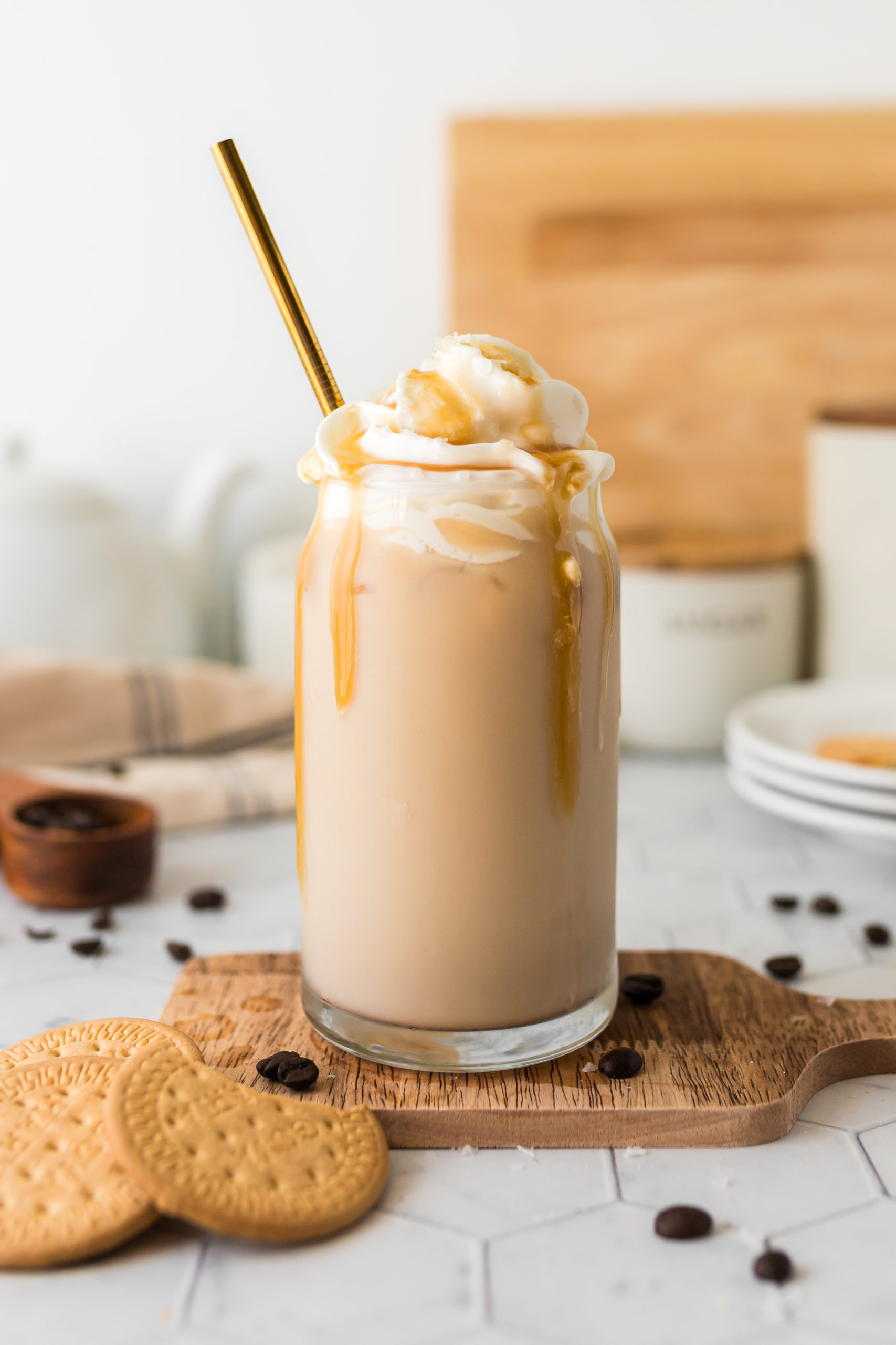 An iced salted caramel latte garnished with whipped cream and caramel sauce. 