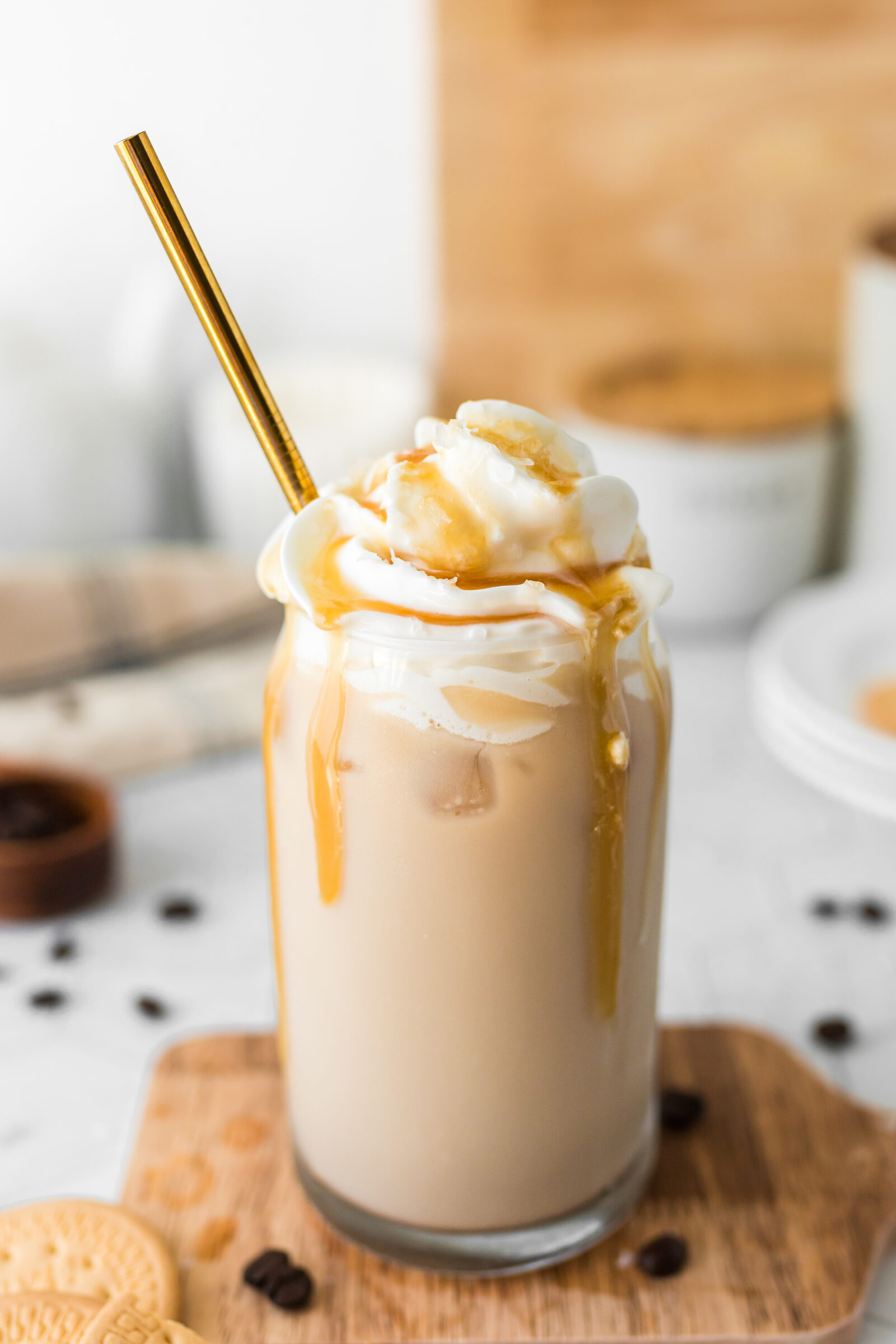 An iced caramel latte topped with whipped cream and drizzled with caramel sauce. 