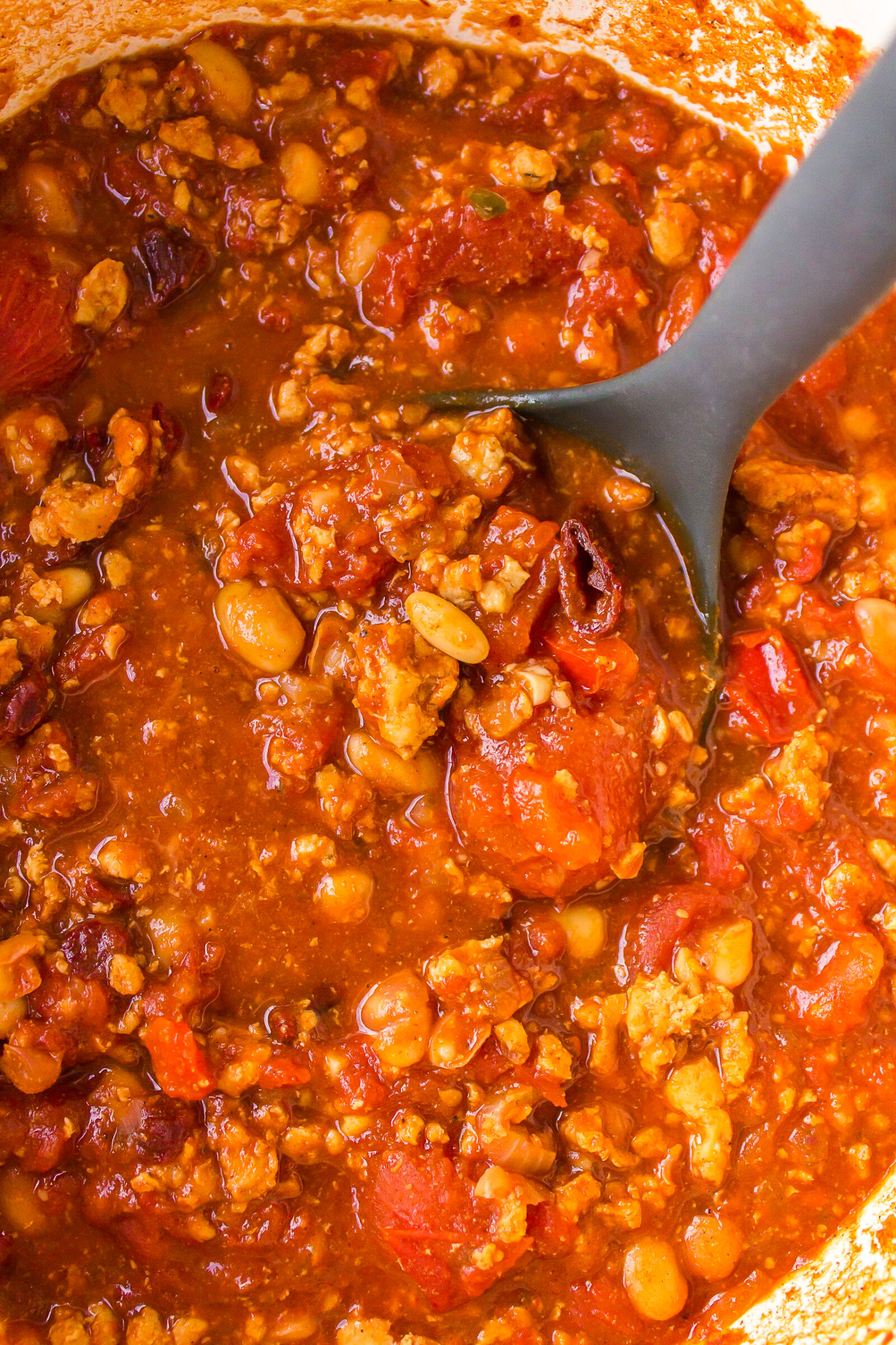 An overhead view of turkey white bean chili in a dutch oven. 