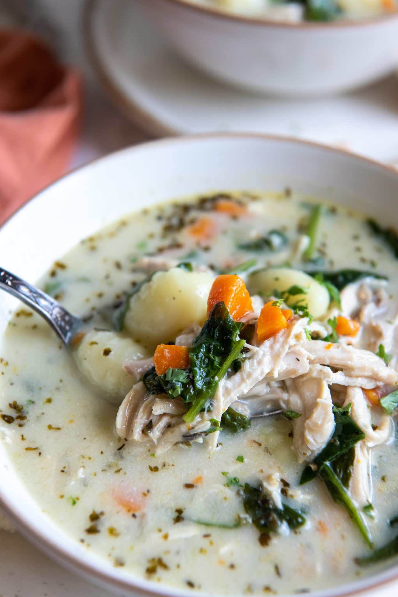 creamy chicken gnocchi soup in a white bowl