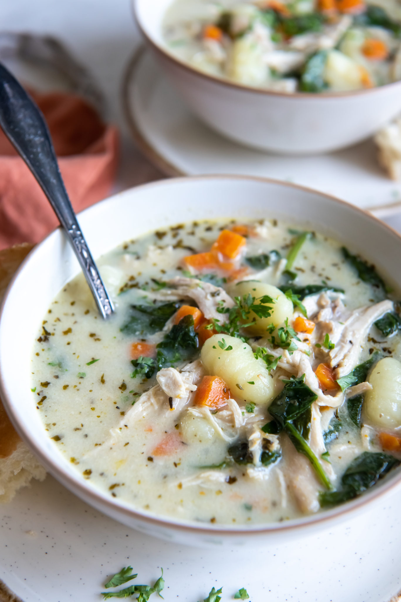 Instant Pot chicken and gnocchi soup in a white bowl