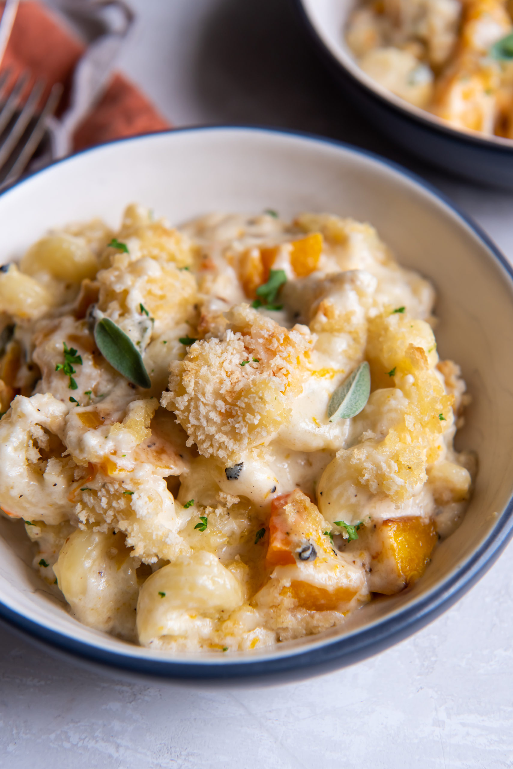 A bowl full of butternut squash macaroni and cheese
