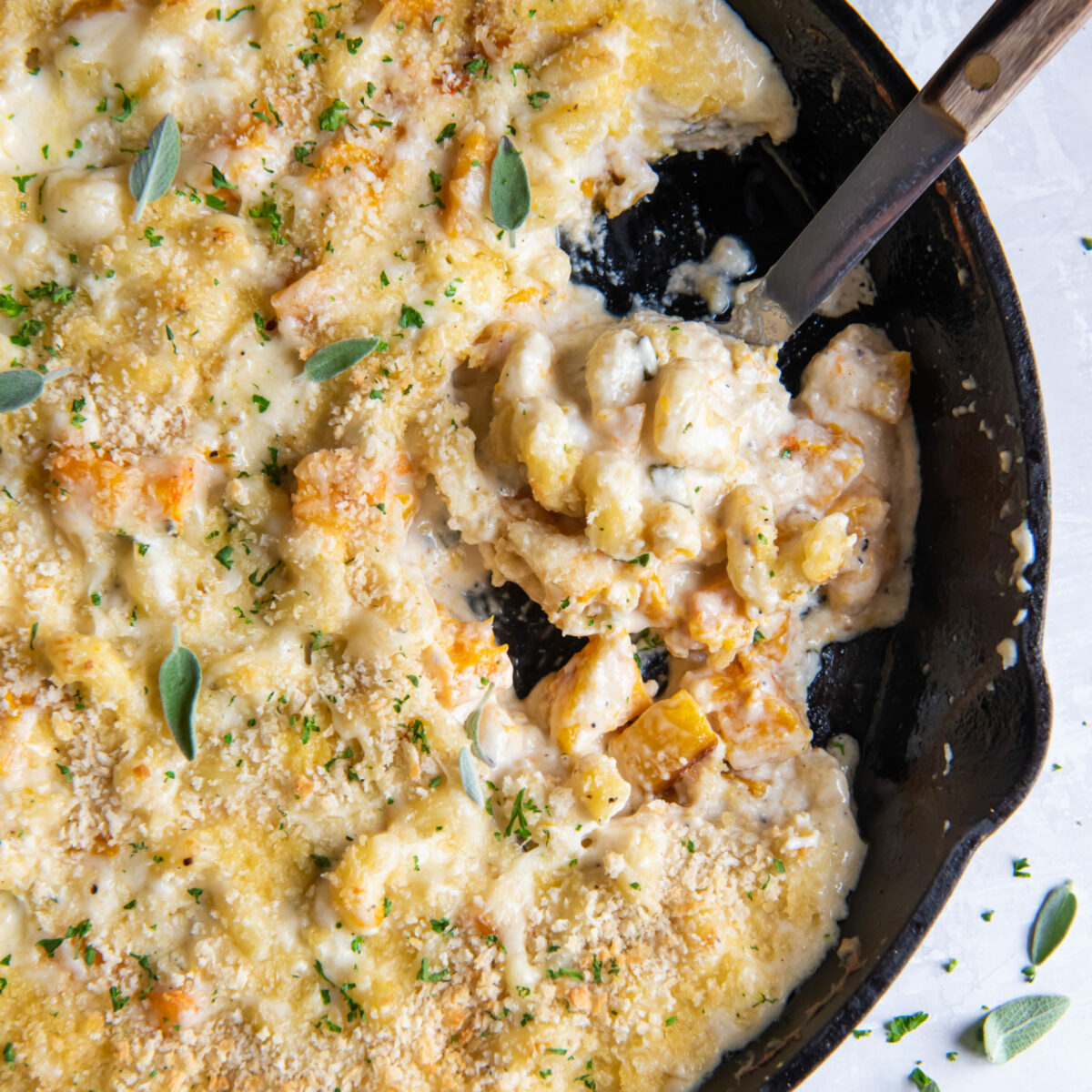 Overhead view of a skillet full of butternut squash mac and cheese. 