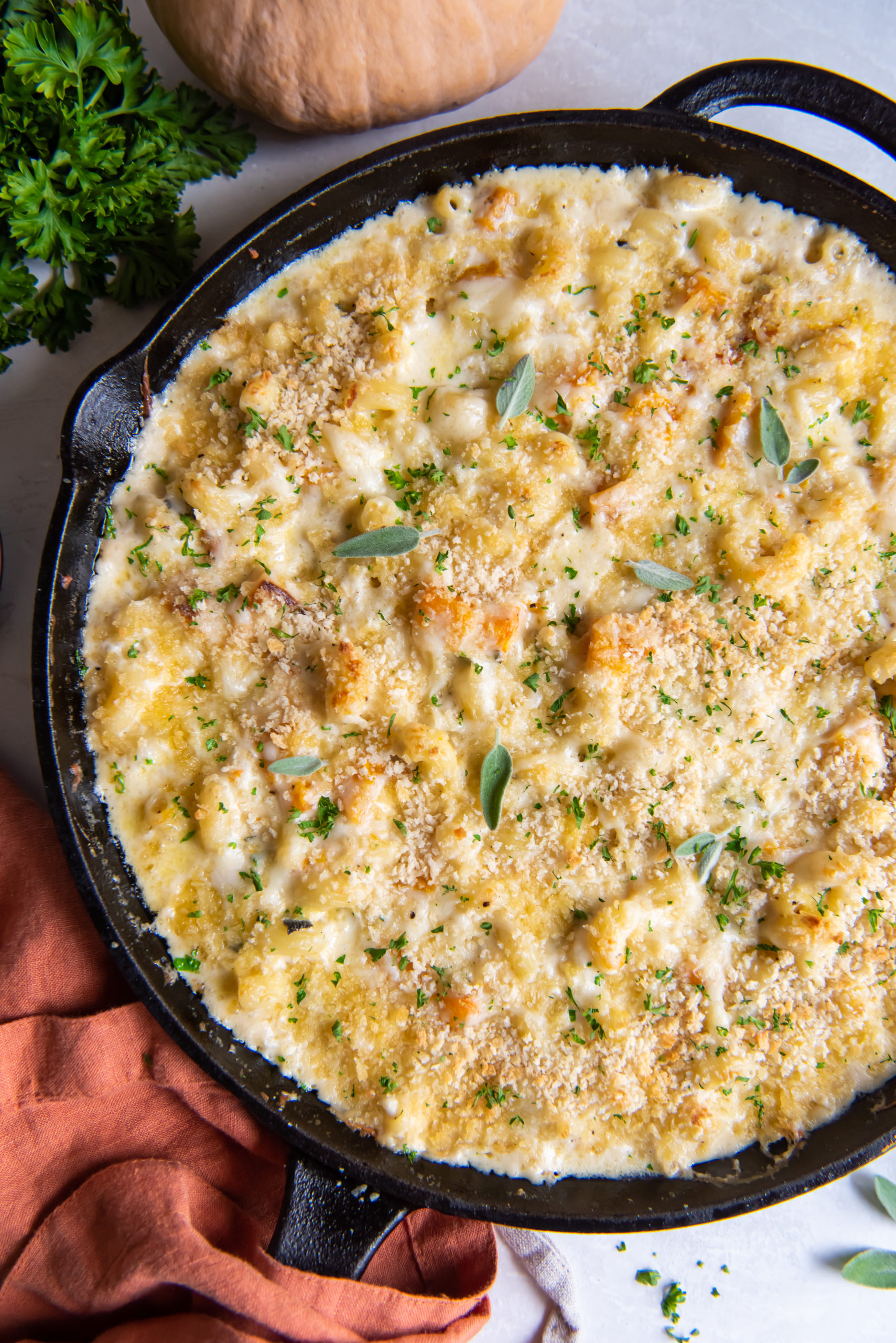 Overhead view of a skillet of mac and cheese made with butternut squash