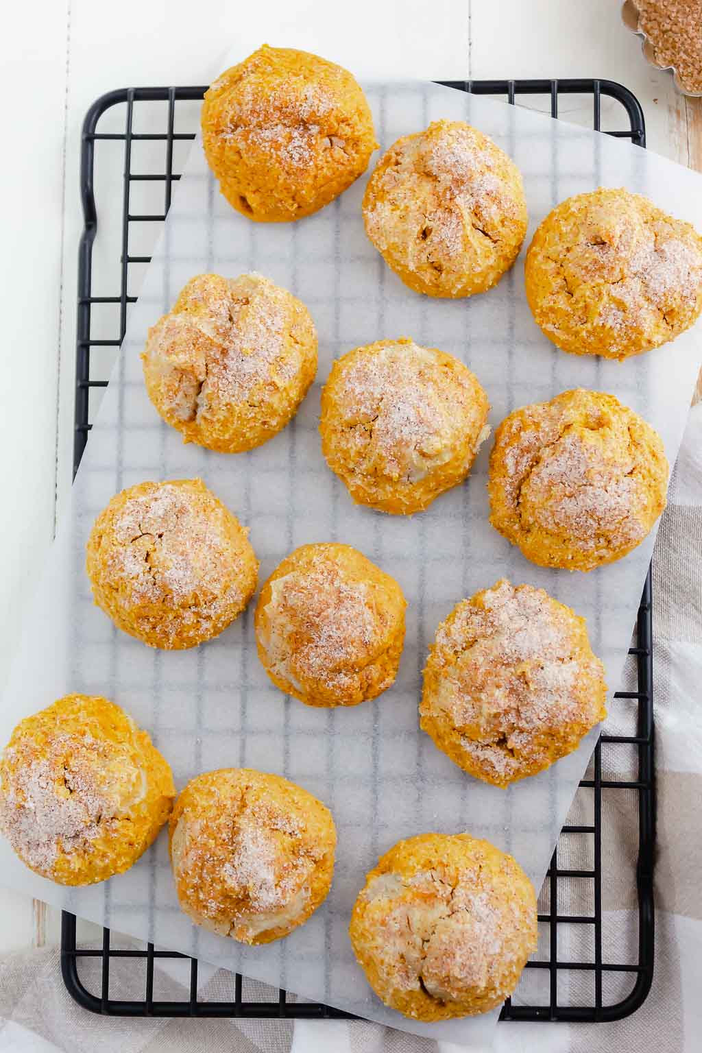 cookies on a wire rack with white parchment paper