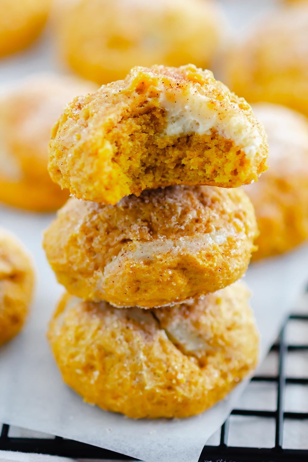 cookies on a wire rack with white parchment paper