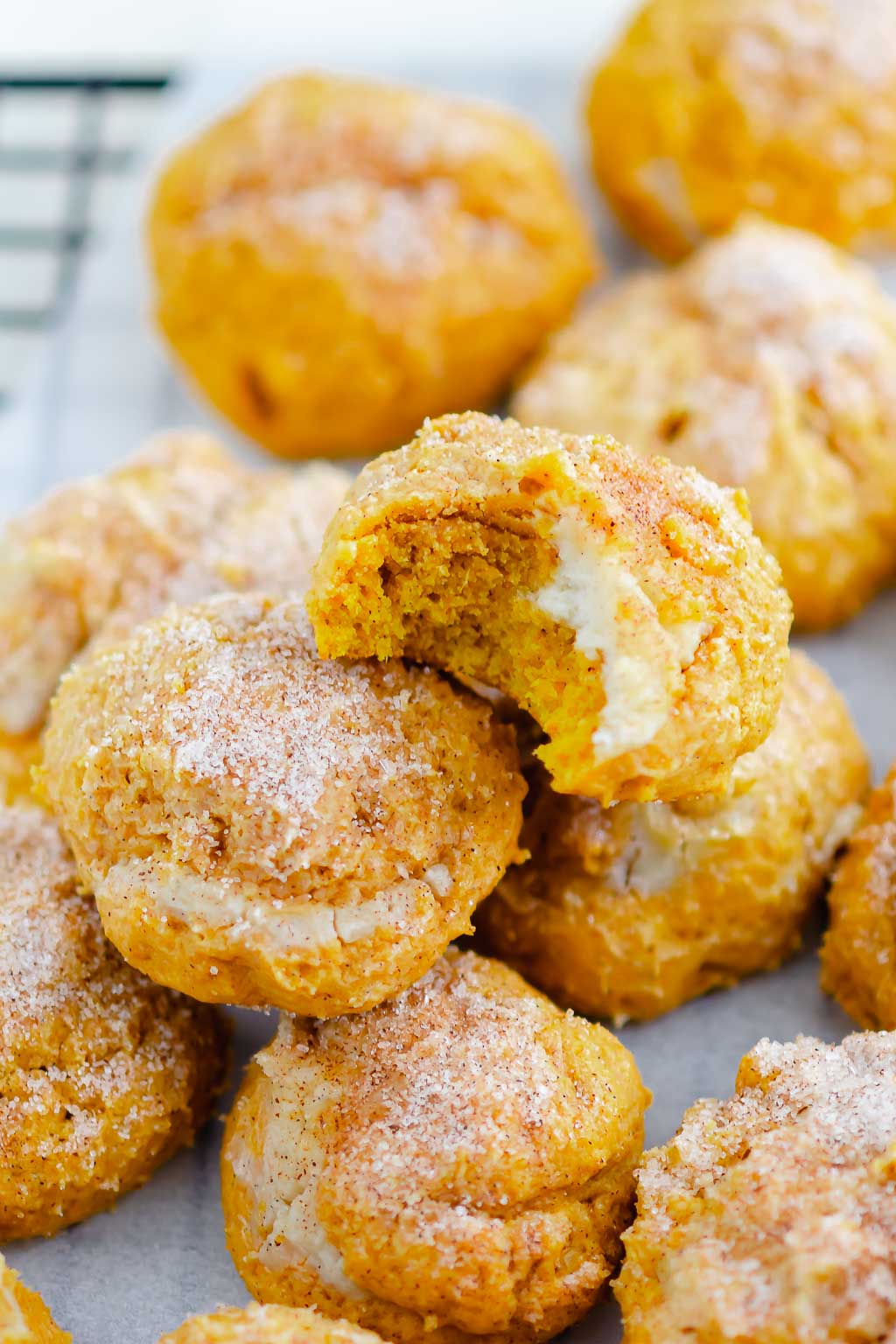 cookies on a wire rack with white parchment paper