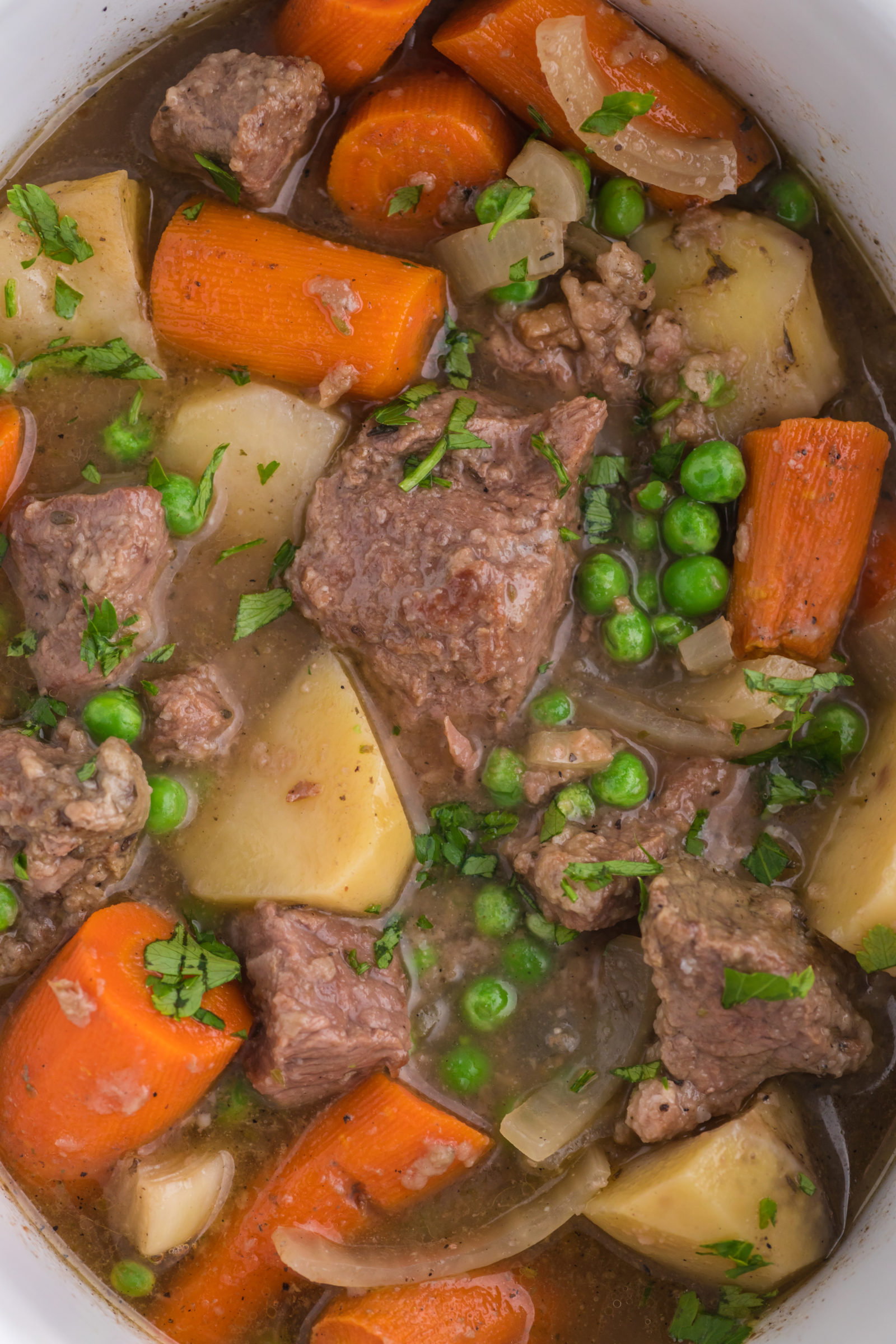 An overhead view of old fashioned beef stew in a slow cooker. 
