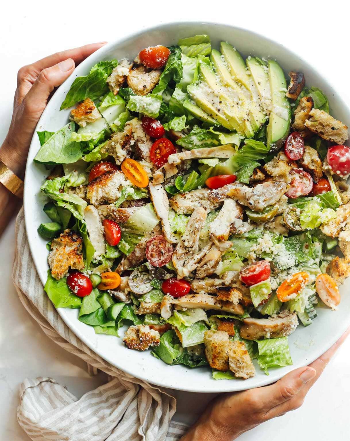grilled chicken caesar salad in a white bowl