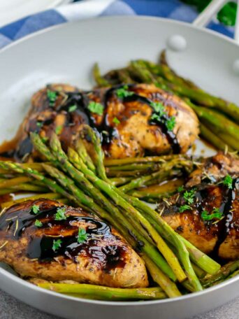 chicken and asparagus in a skillet