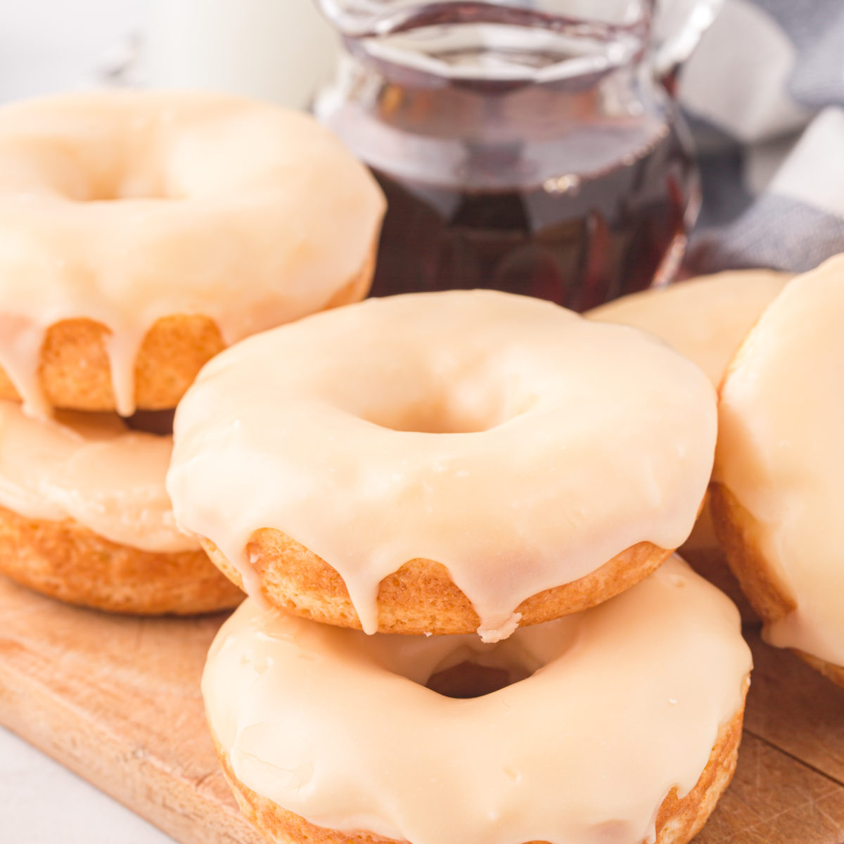 donuts on a wooden board with maple syrup