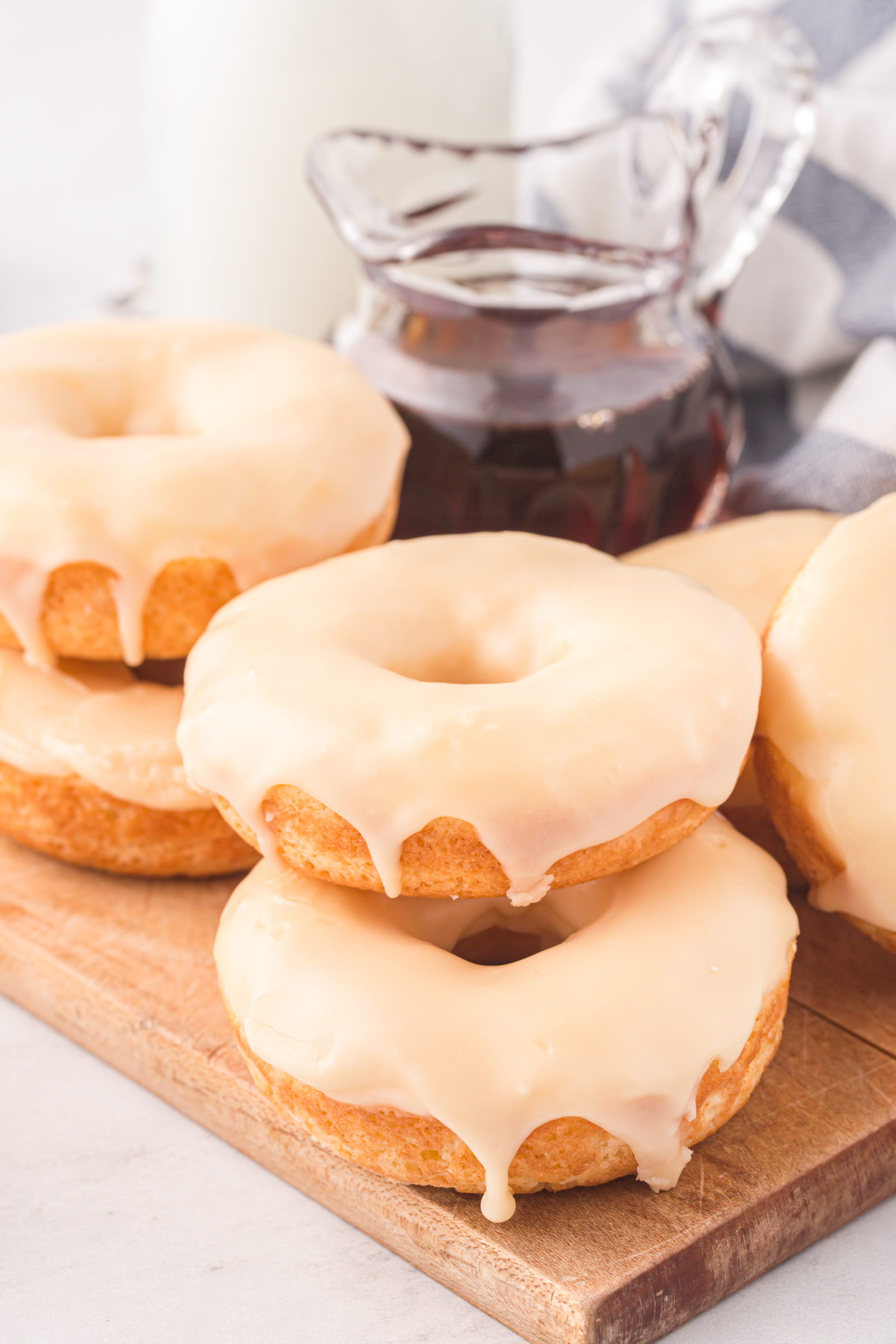 donuts on a wooden board with maple syrup