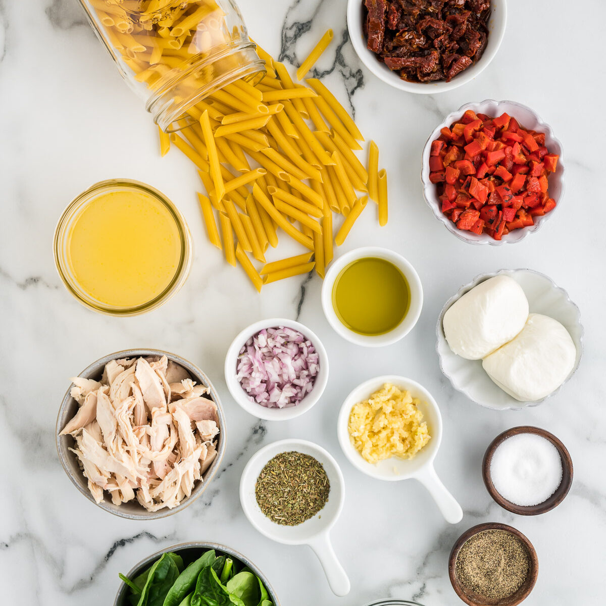 ingredients for pasta on a white surface