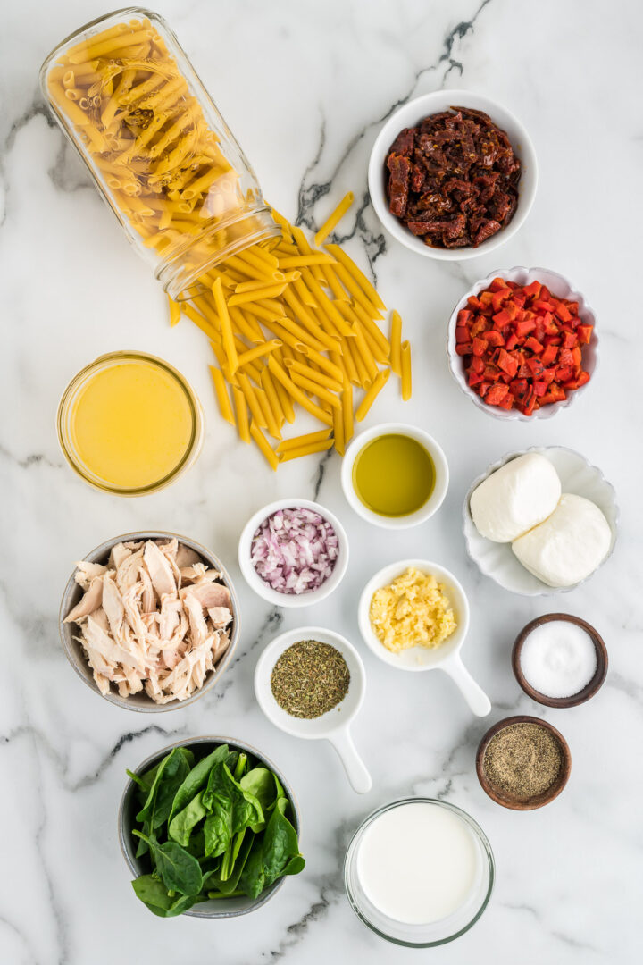 ingredients for pasta on a white surface