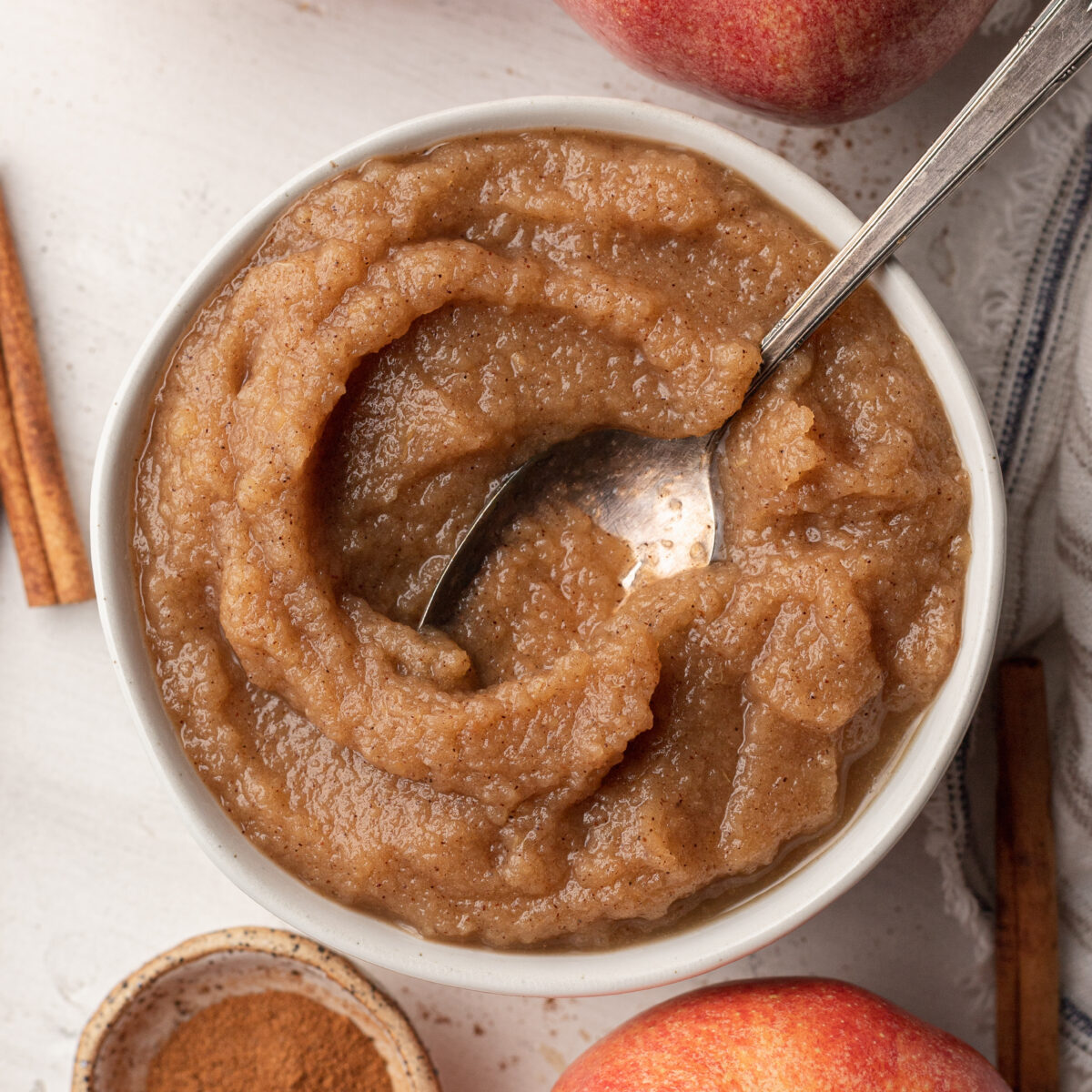 applesauce in a white bowl with a spoon
