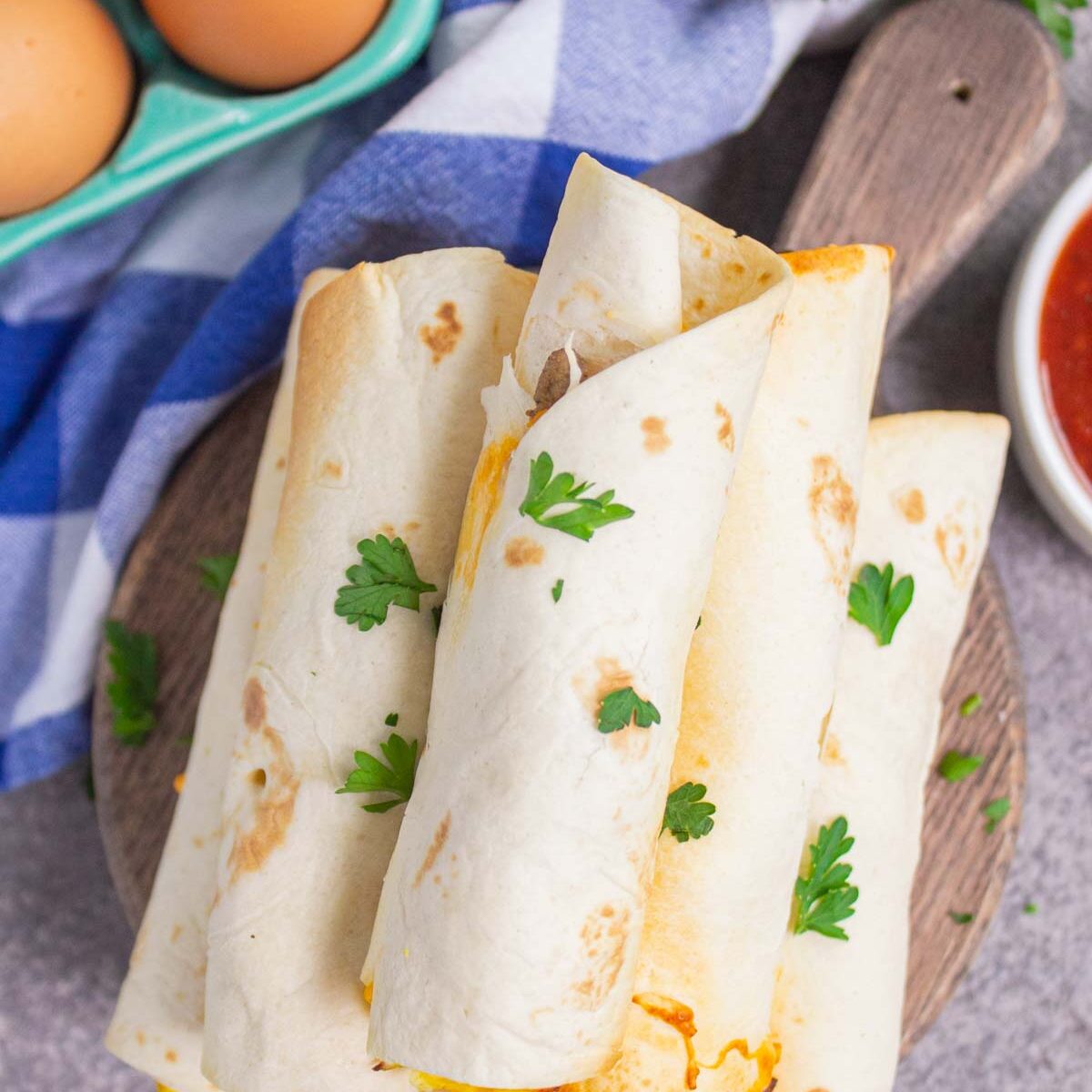 taquitos on a wooden serving board