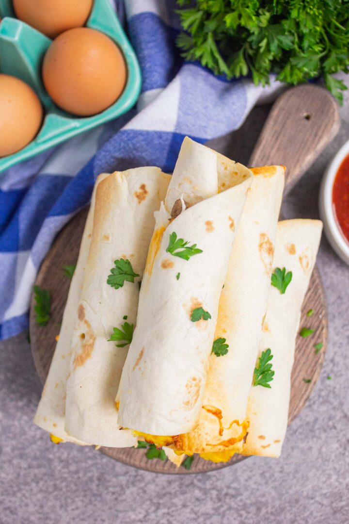 taquitos on a wooden serving board